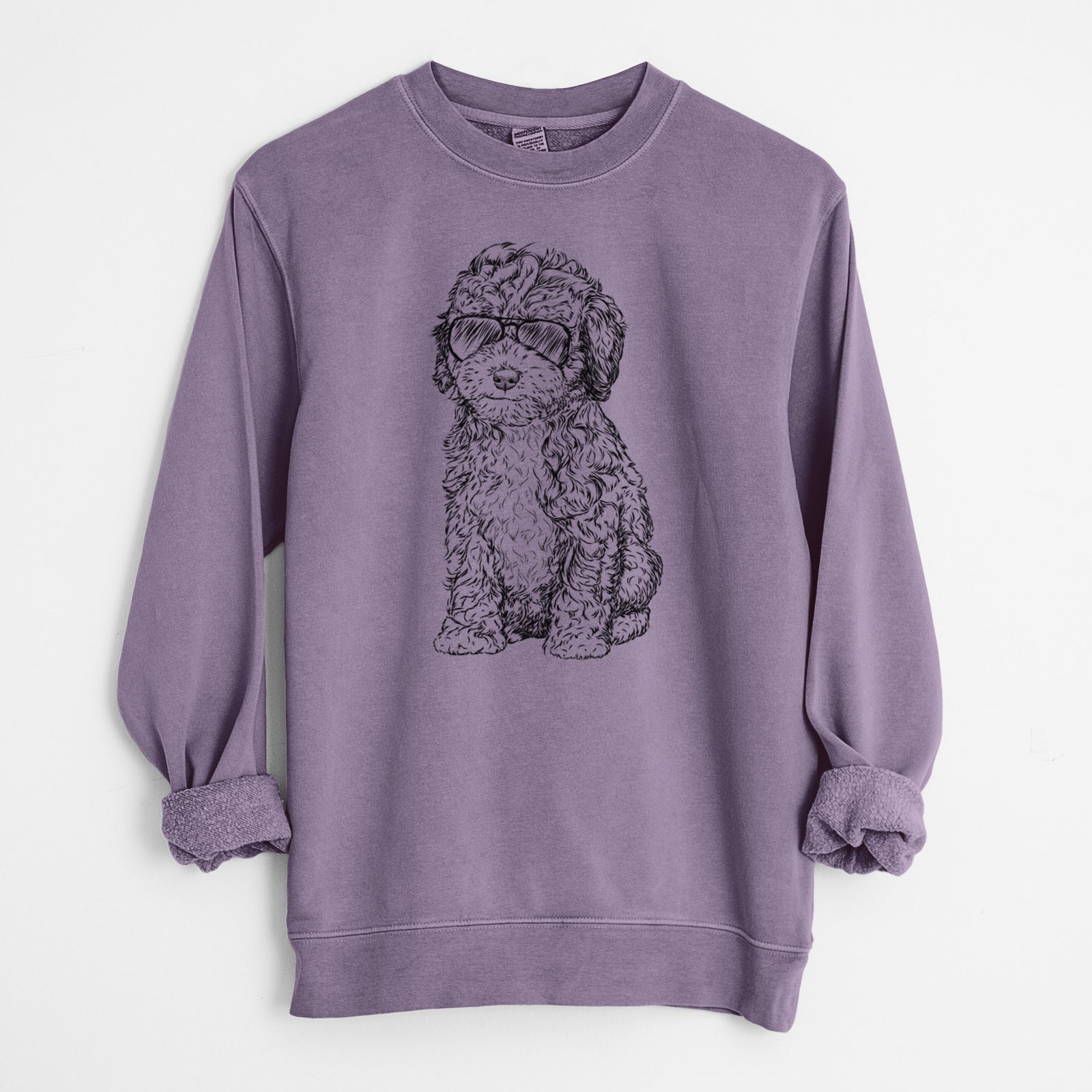 Hand-drawn sketch of Sweet Tea the Mini Doodle wearing aviator sunglasses on a Plum Unisex pigment dyed crew sweatshirt