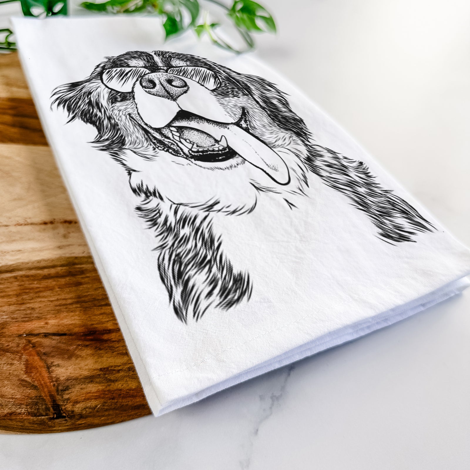 Hand-drawn sketch of Theo the Bernese Mountain Dog wearing aviator sunglasses on a tea towel