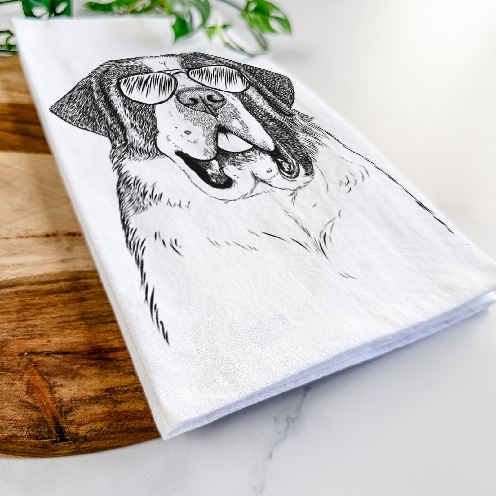 Hand-drawn sketch of Thor the Saint Bernard wearing aviator sunglasses on a tea towel
