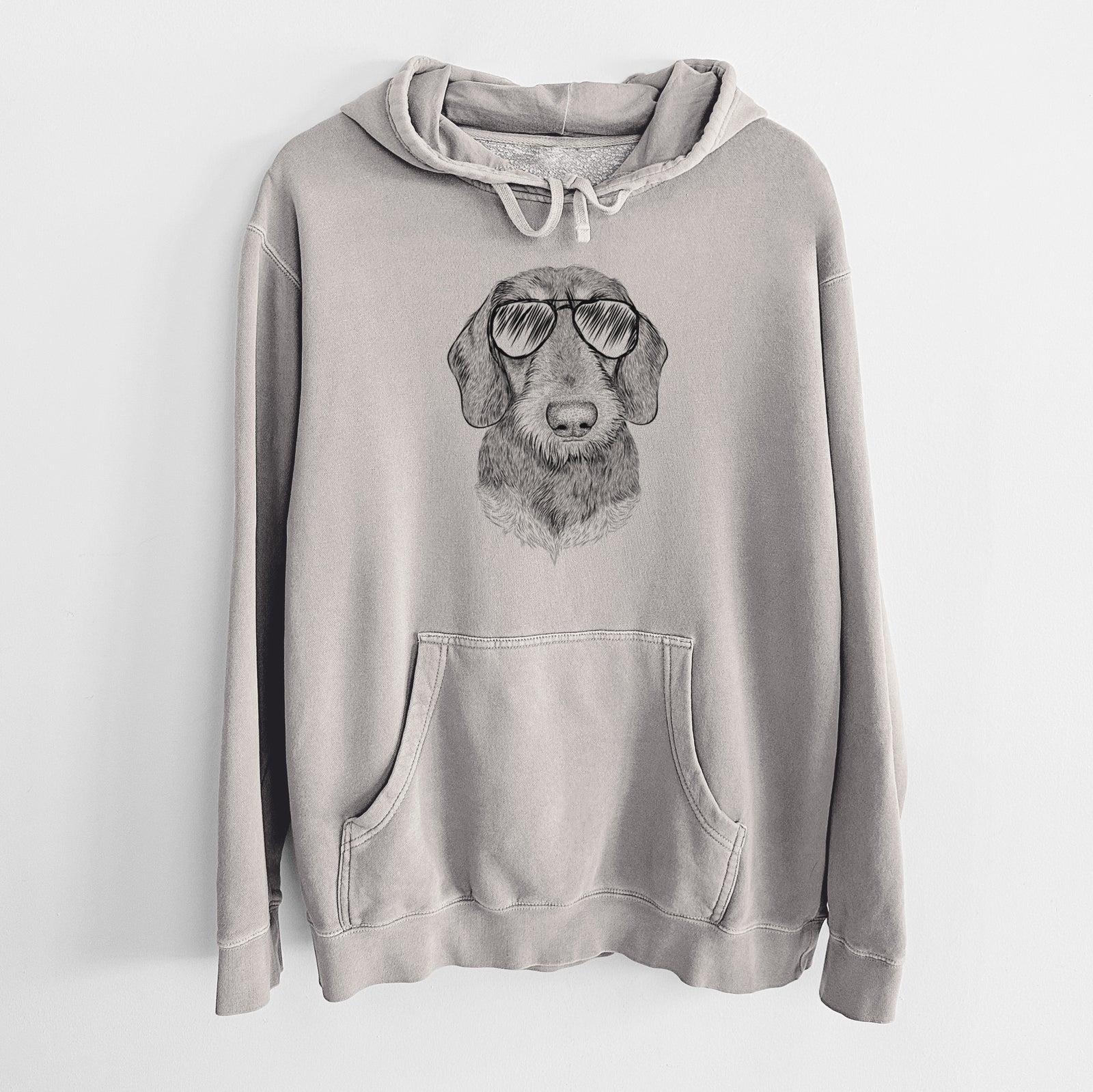 Hand-drawn sketch of Truman the Wirehaired Dachshund wearing aviator sunglasses on a Cement Unisex pigment dyed hoodie