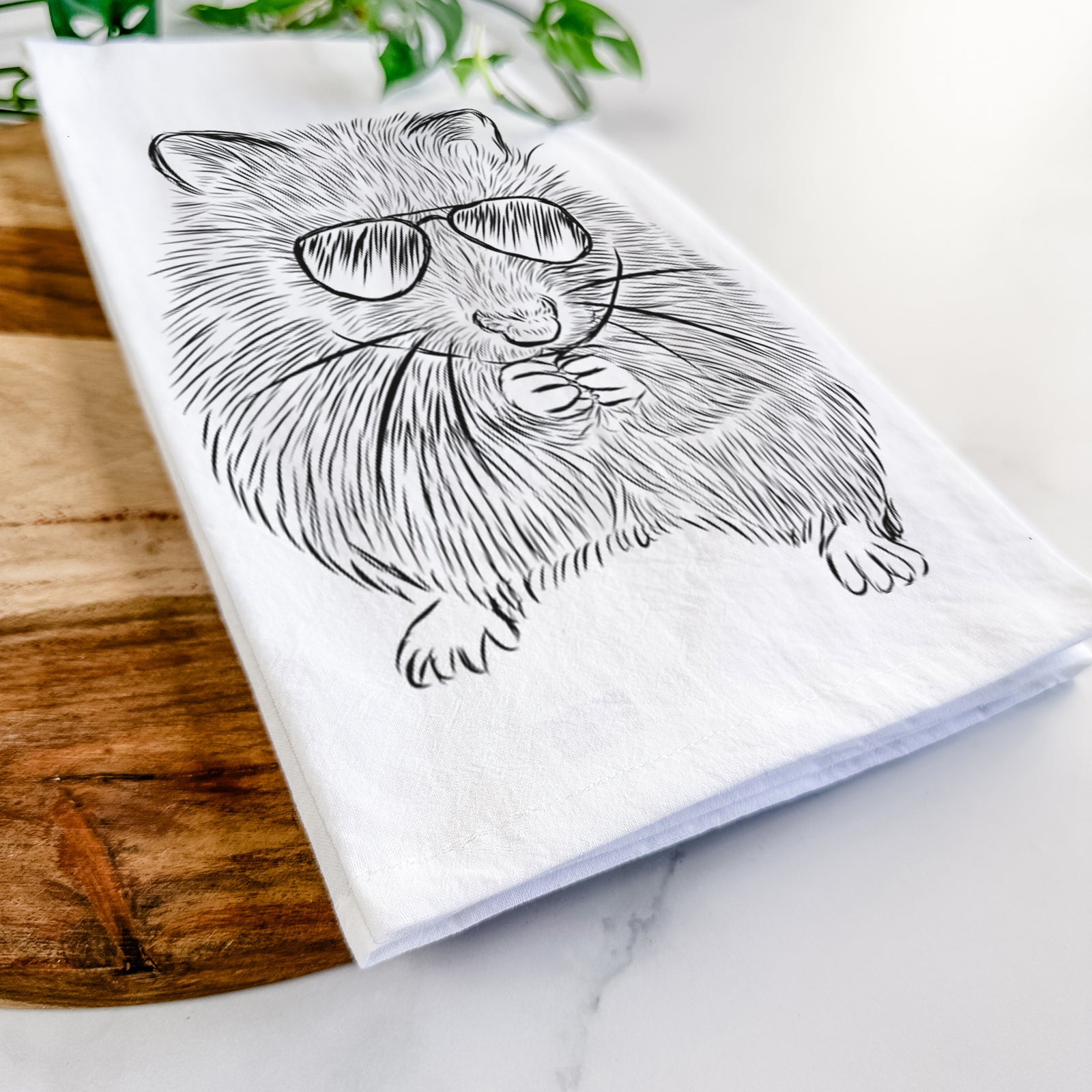 Hand-drawn sketch of Twitch the Hamster wearing aviator sunglasses on a tea towel