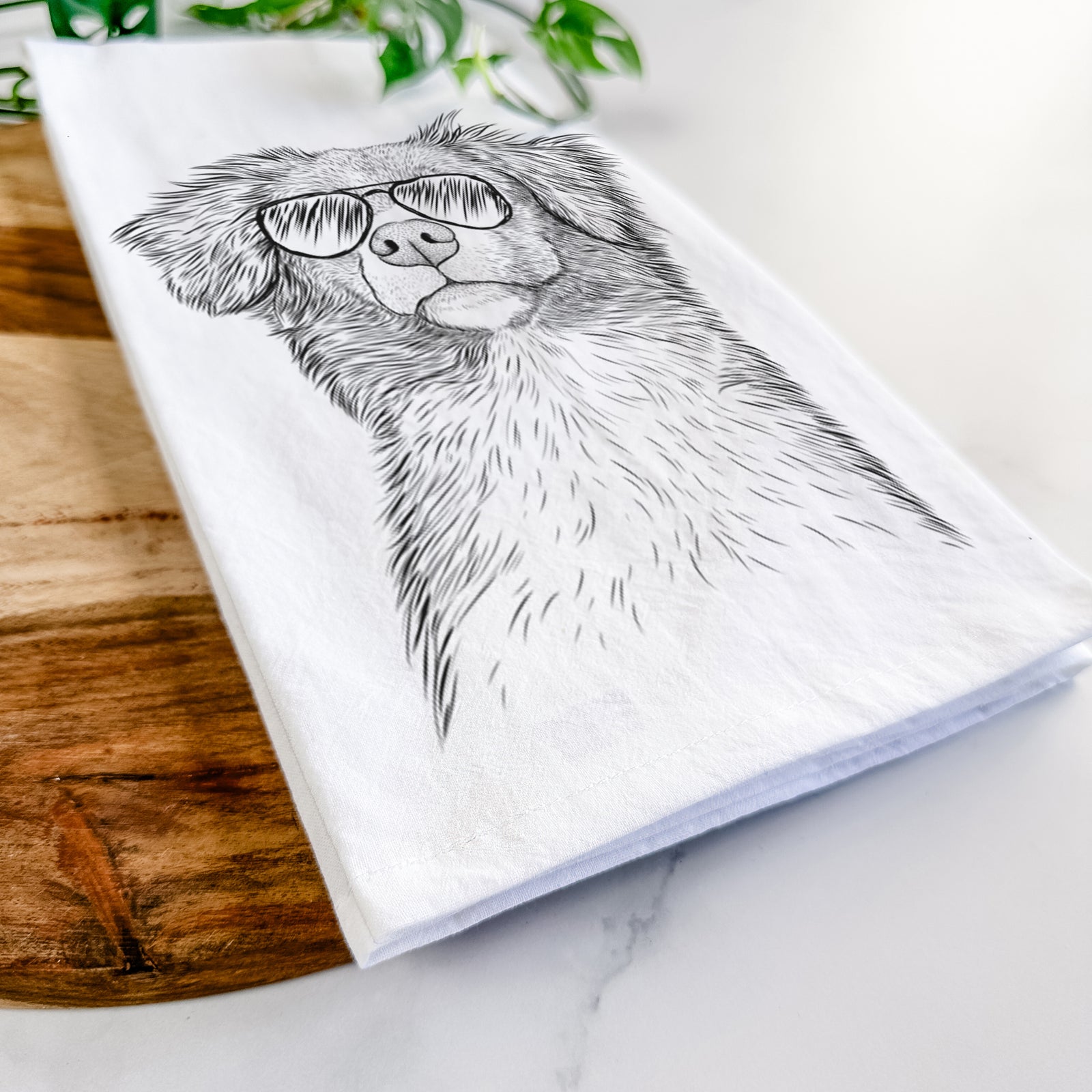 Hand-drawn sketch of Vixen the Nova Scotia Duck Tolling Retriever wearing aviator sunglasses on a tea towel