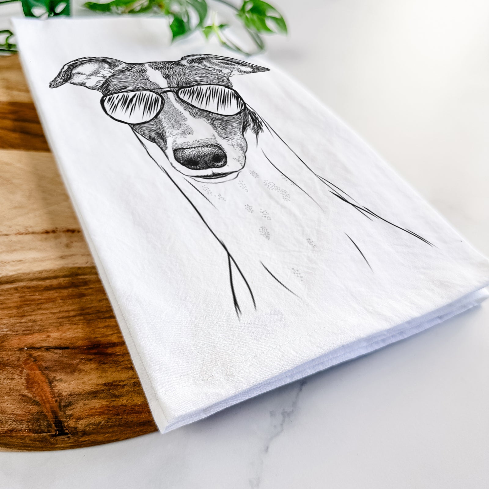 Hand-drawn sketch of Vyncent the Greyhound wearing aviator sunglasses on a tea towel