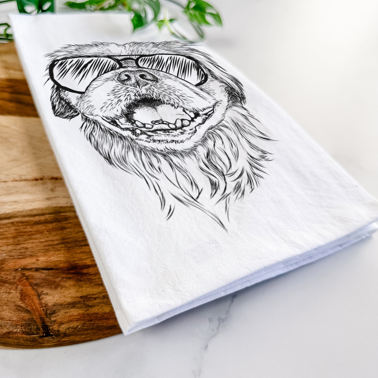 Hand-drawn sketch of Wally the Pekingese wearing aviator sunglasses on a tea towel