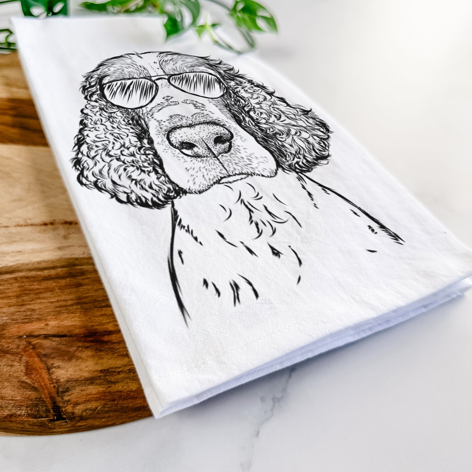 Hand-drawn sketch of Wilbur the English Springer Spaniel wearing aviator sunglasses on a tea towel