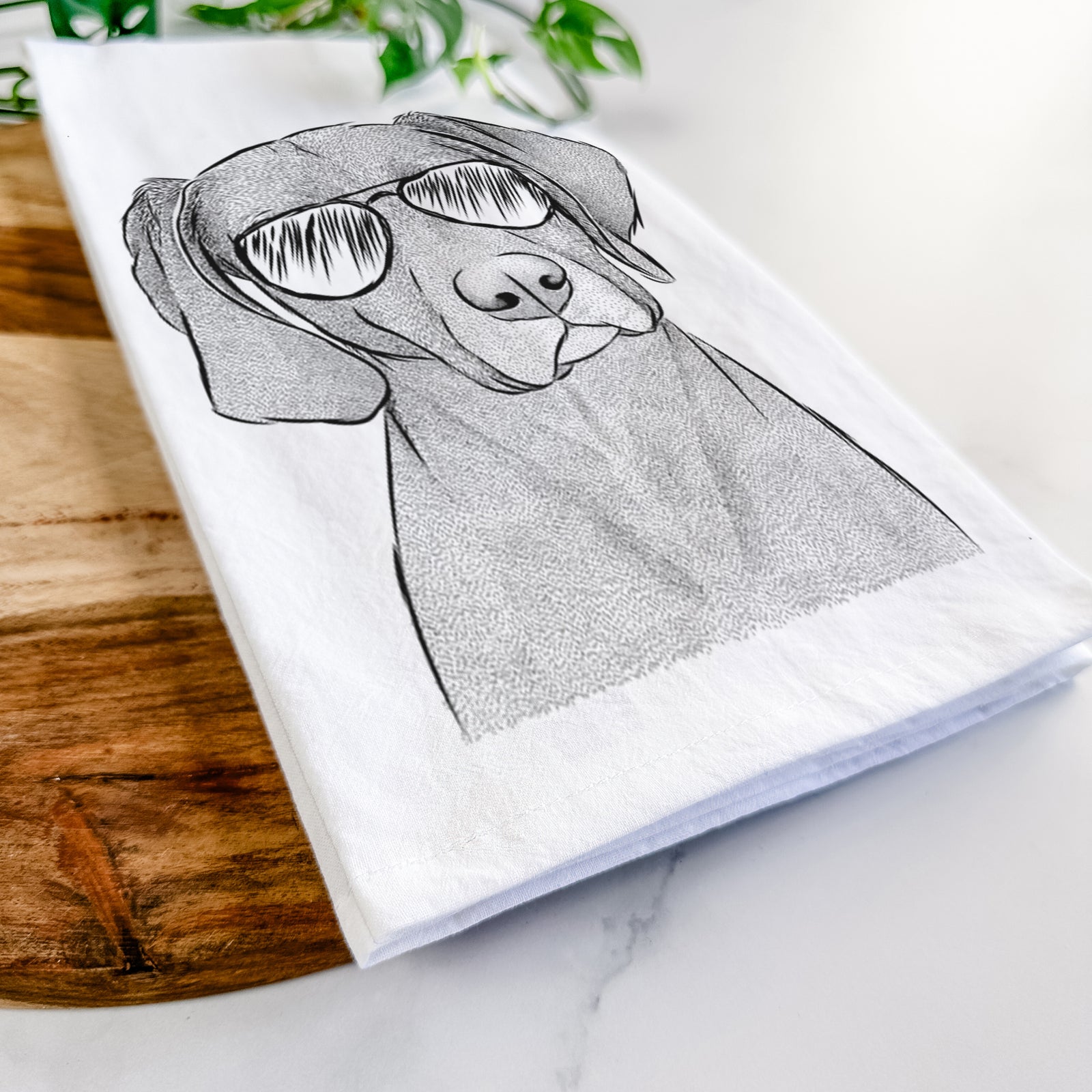 Hand-drawn sketch of Willow the Weizsla wearing aviator sunglasses on a tea towel