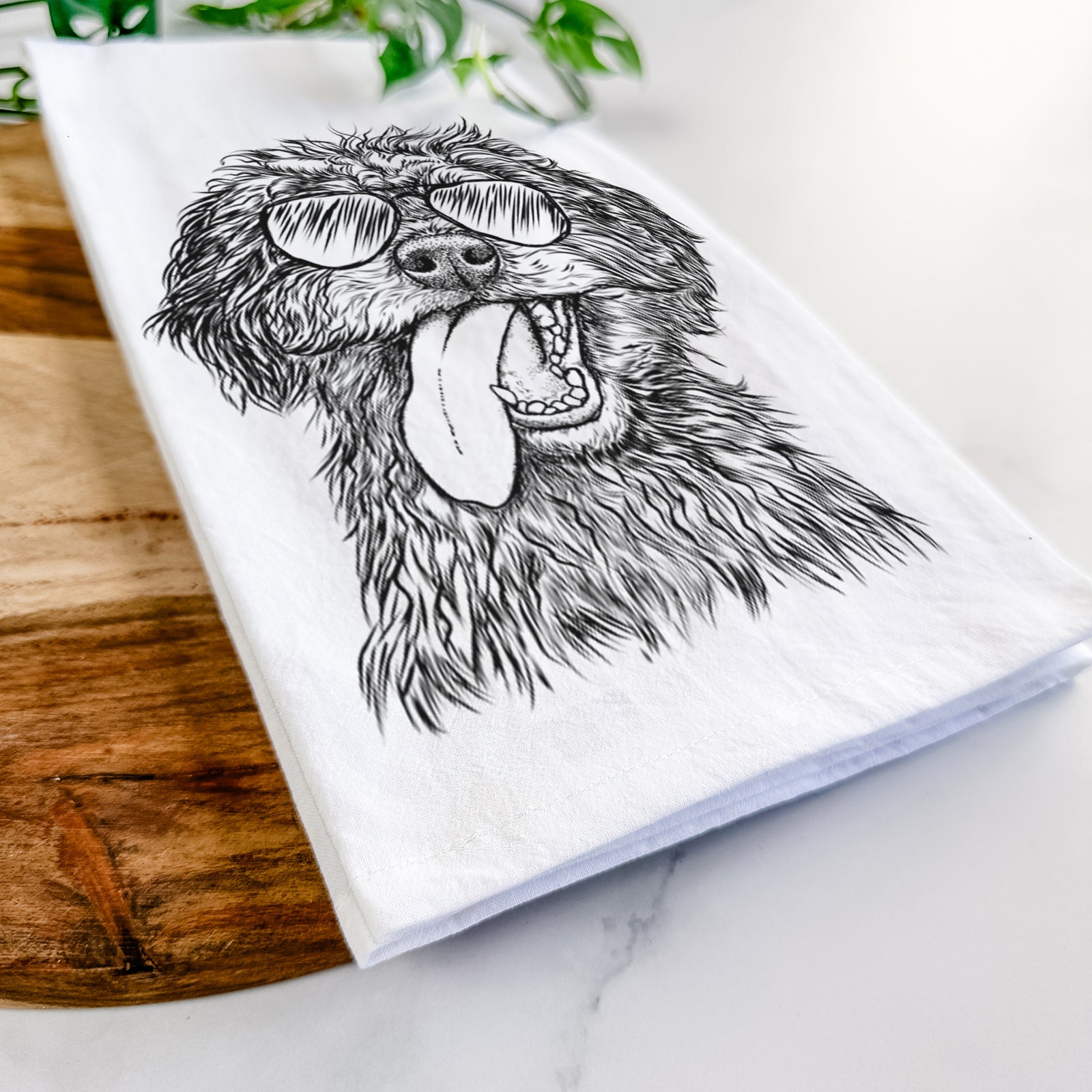 Hand-drawn sketch of Winnie the Mini Aussiedoodle wearing aviator sunglasses on a tea towel