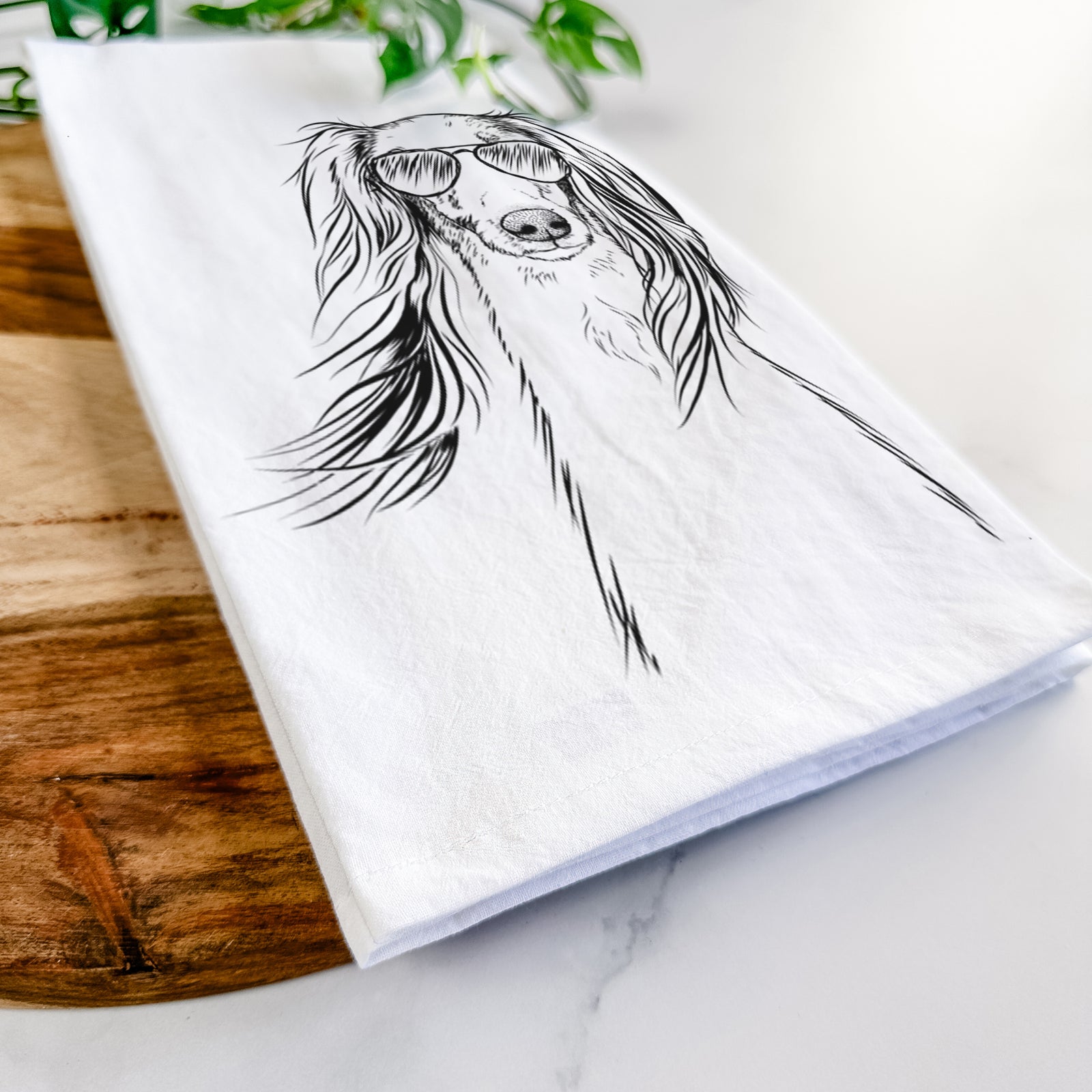 Hand-drawn sketch of Zahra the Saluki wearing aviator sunglasses on a tea towel