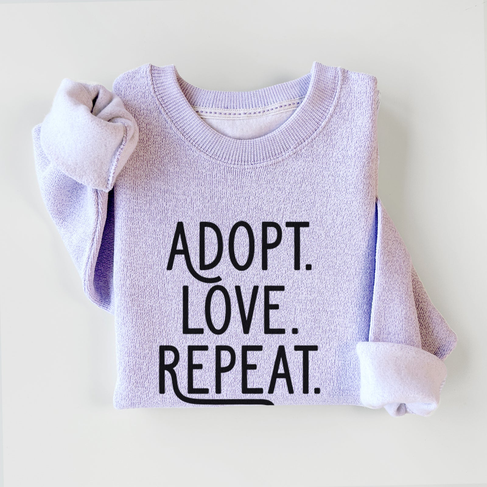 'Adopt Love Repeat' design on an Ice Purple knit sweatshirt