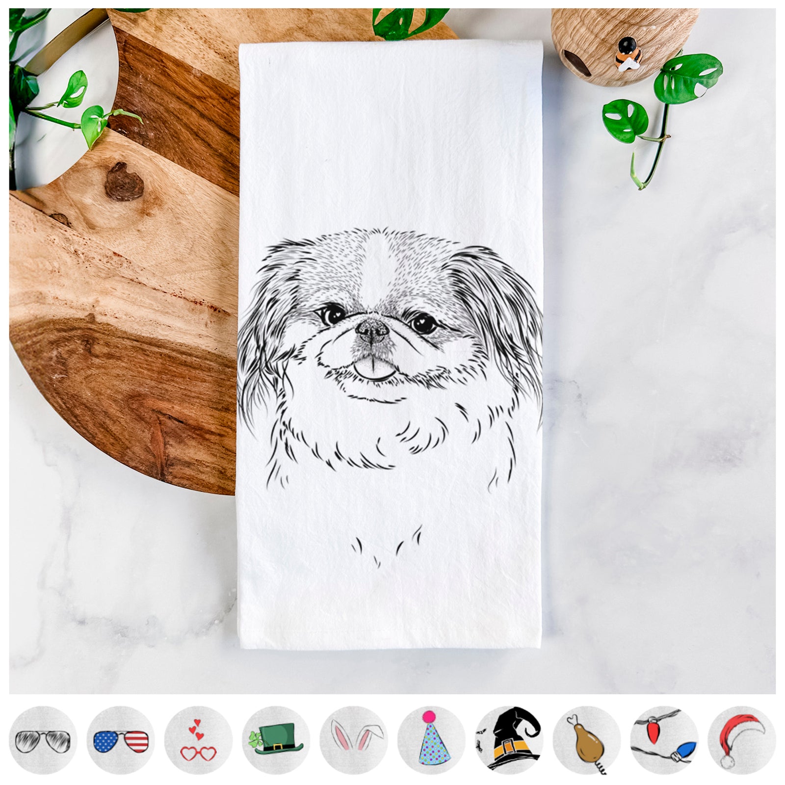 Hand-drawn sketch of Abra Bean the Pekingese on a tea towel, shown with icons of the other available costume styles