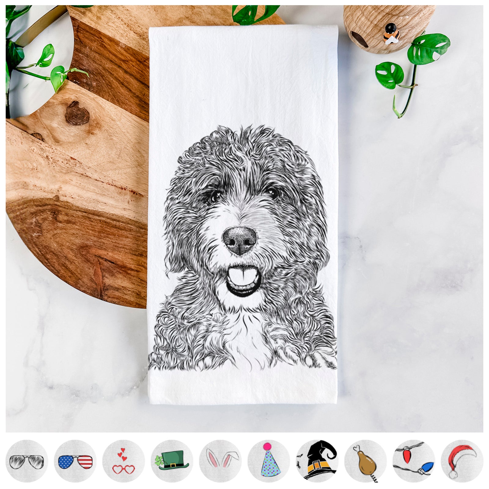 Hand-drawn sketch of Bash the Bernedoodle on a tea towel, shown with icons of the other available costume styles