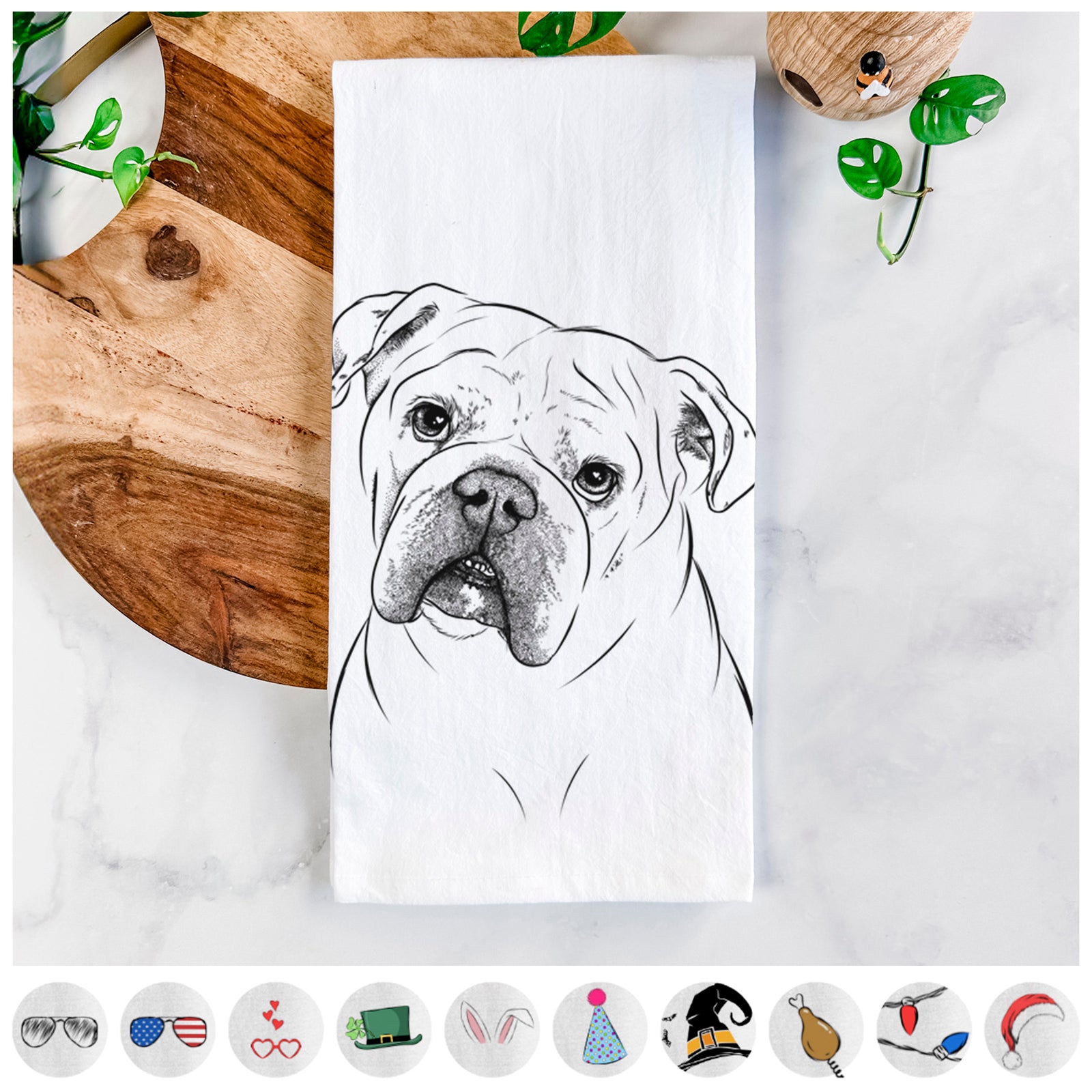 Hand-drawn sketch of Blossom the English Bulldog on a tea towel, shown with icons of the other available costume styles