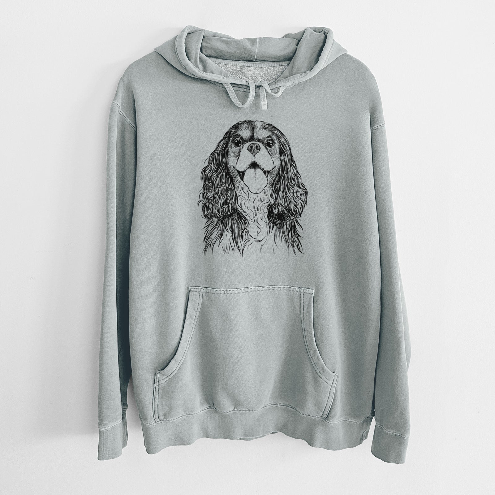 Hand-drawn sketch of Brandy the Cavalier King Charles Spaniel on a Sage Unisex pigment dyed hoodie