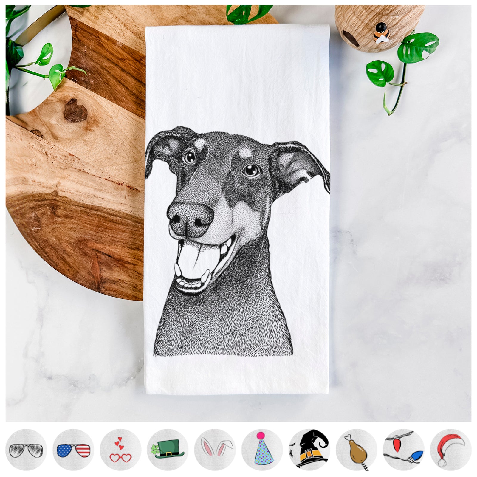 Hand-drawn sketch of Bunnie the Doberman Pinscher on a tea towel, shown with icons of the other available costume styles
