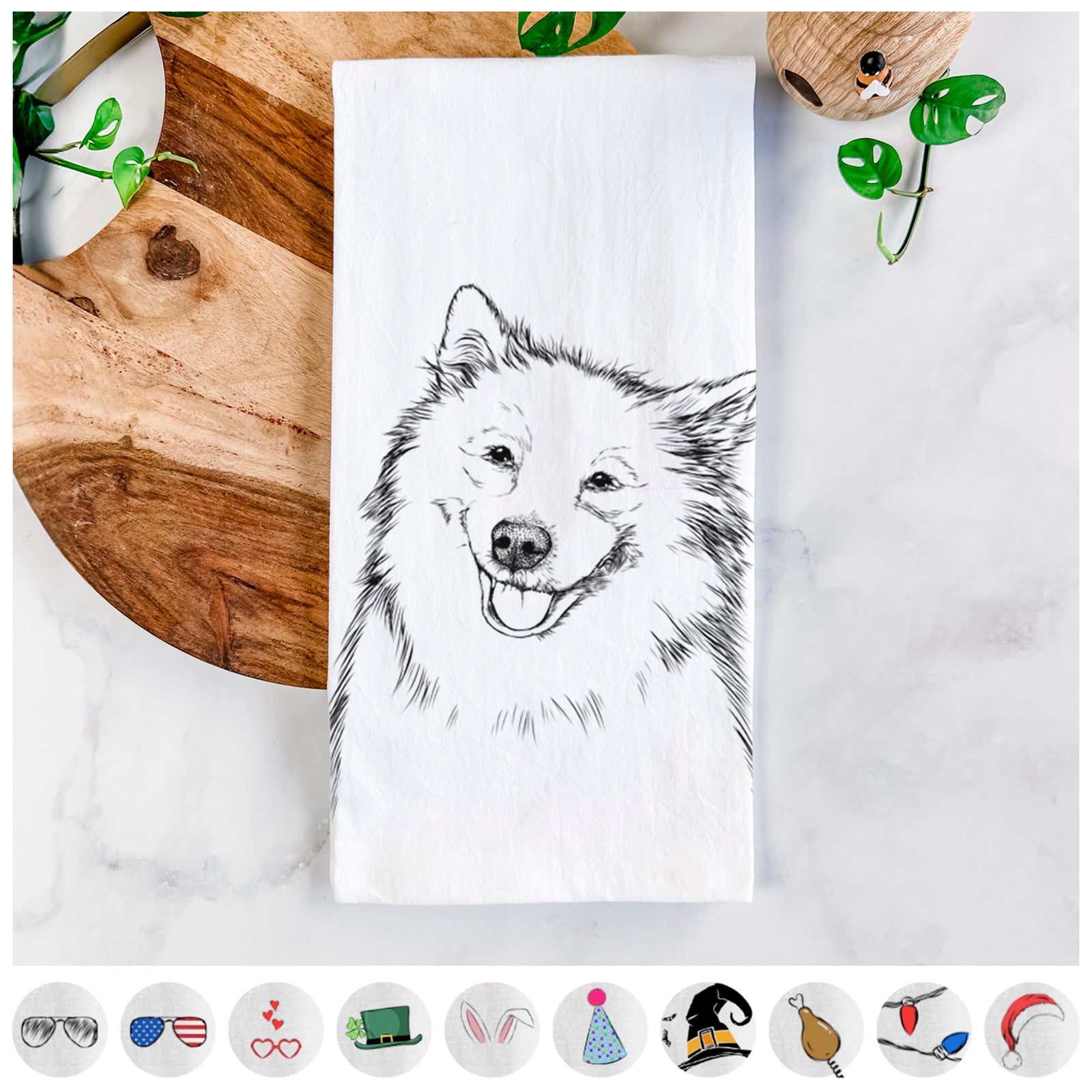 Hand-drawn sketch of Caico the Samoyed on a tea towel, shown with icons of the other available costume styles