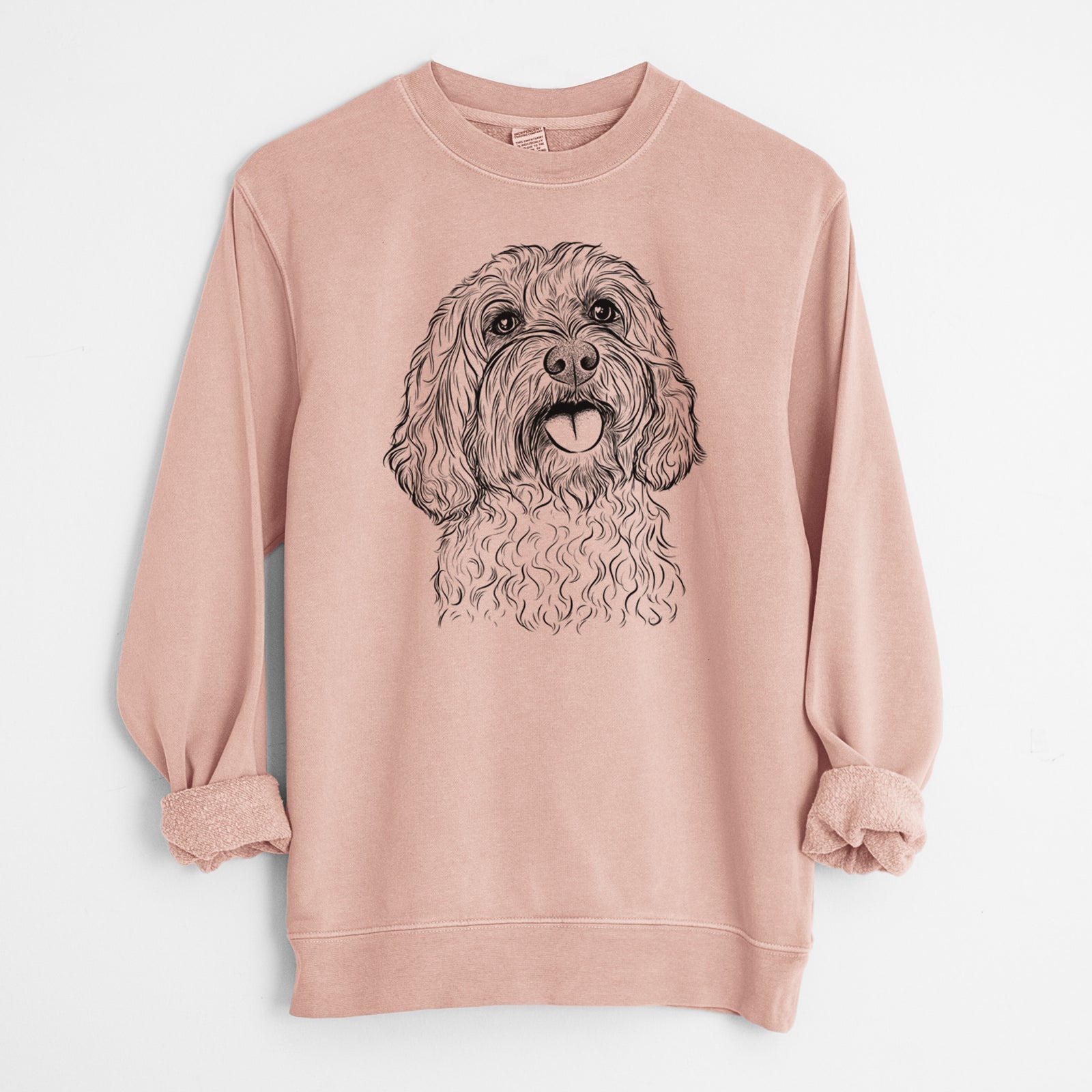 Hand-drawn sketch of Cali the Cavapoo on a Dusty Pink Unisex pigment dyed crew sweatshirt