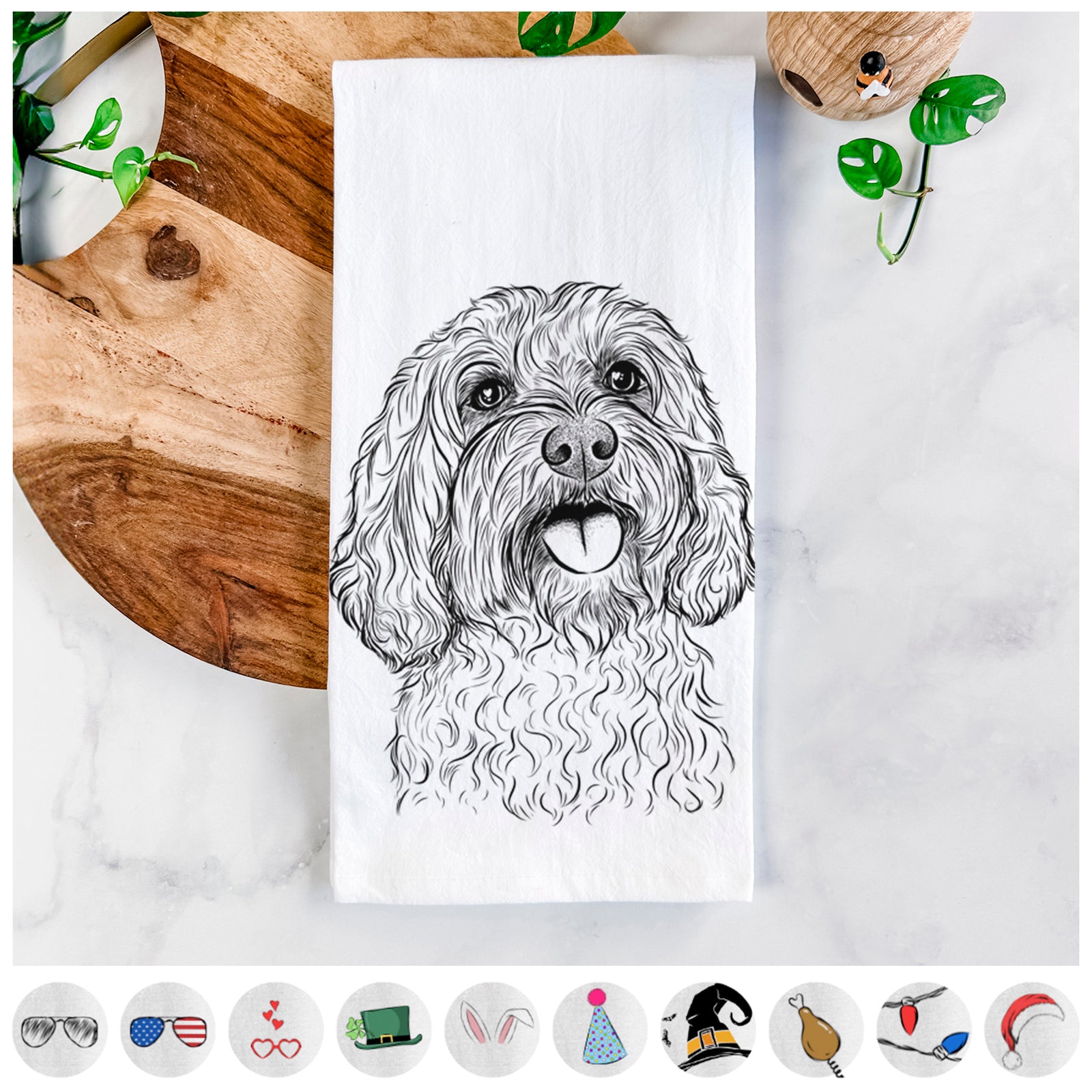Hand-drawn sketch of Cali the Cavapoo on a tea towel, shown with icons of the other available costume styles