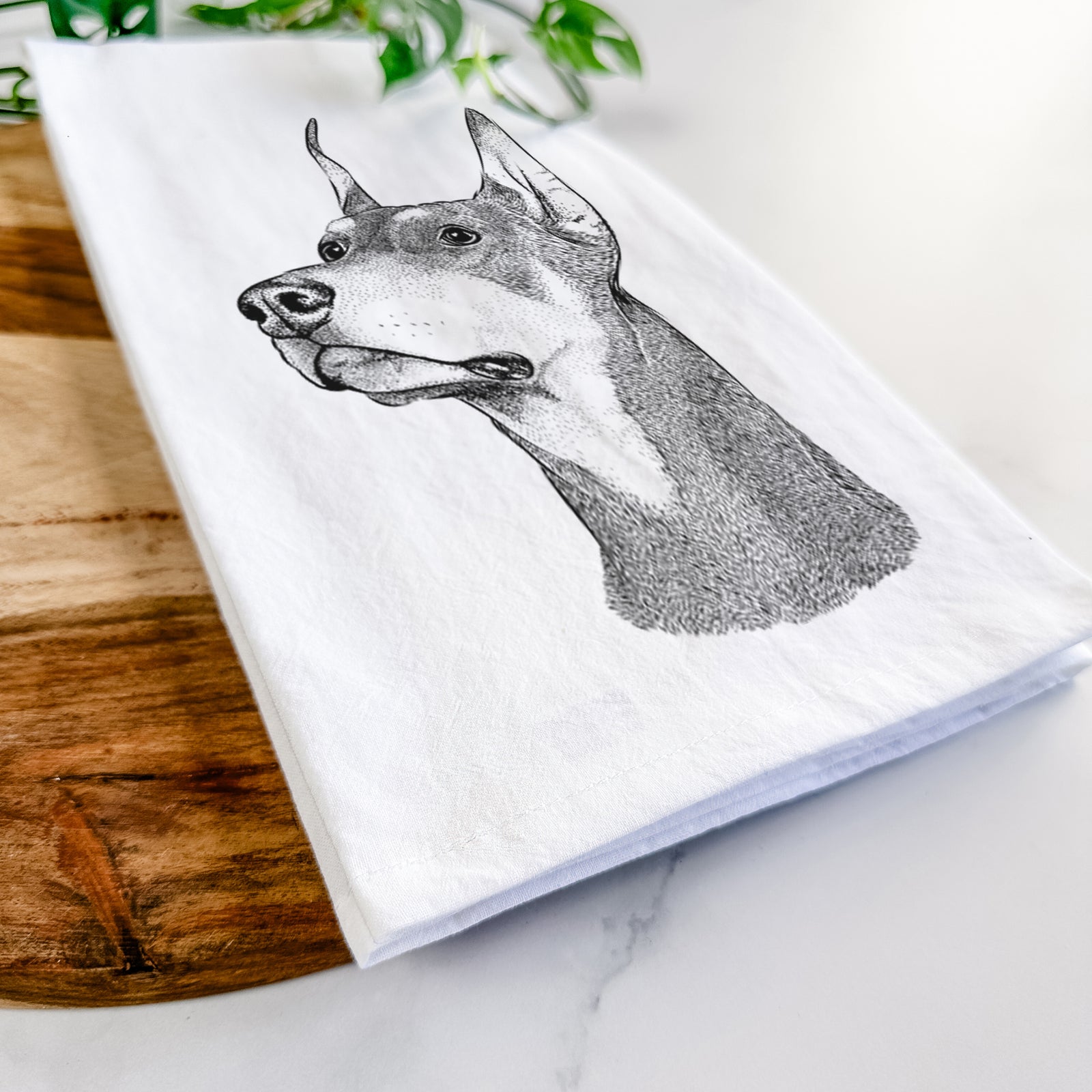 Hand-drawn sketch of Cenza the Doberman Pinscher on a tea towel