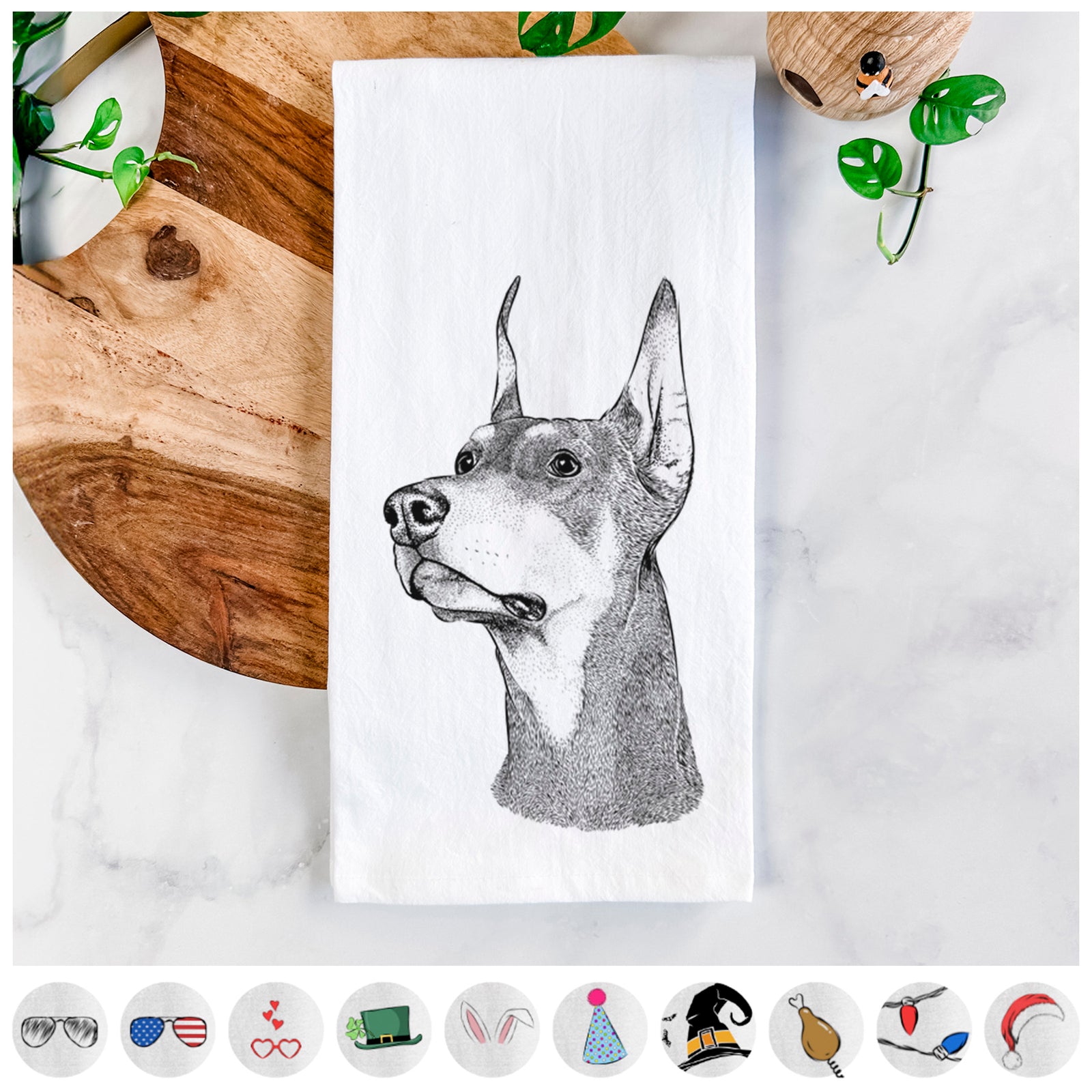 Hand-drawn sketch of Cenza the Doberman Pinscher on a tea towel, shown with icons of the other available costume styles