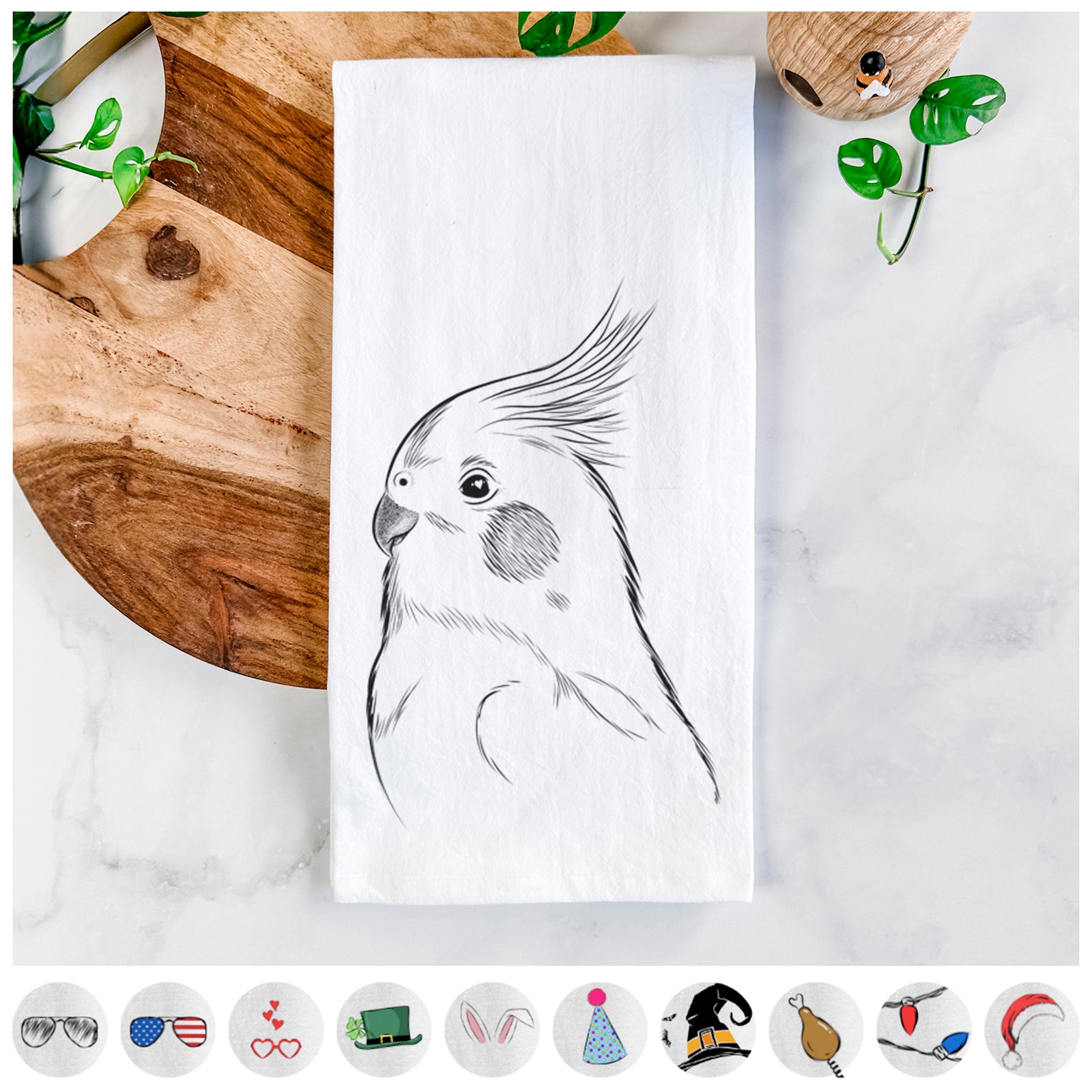 Hand-drawn sketch of Charlie the Cockatiel on a tea towel, shown with icons of the other available costume styles