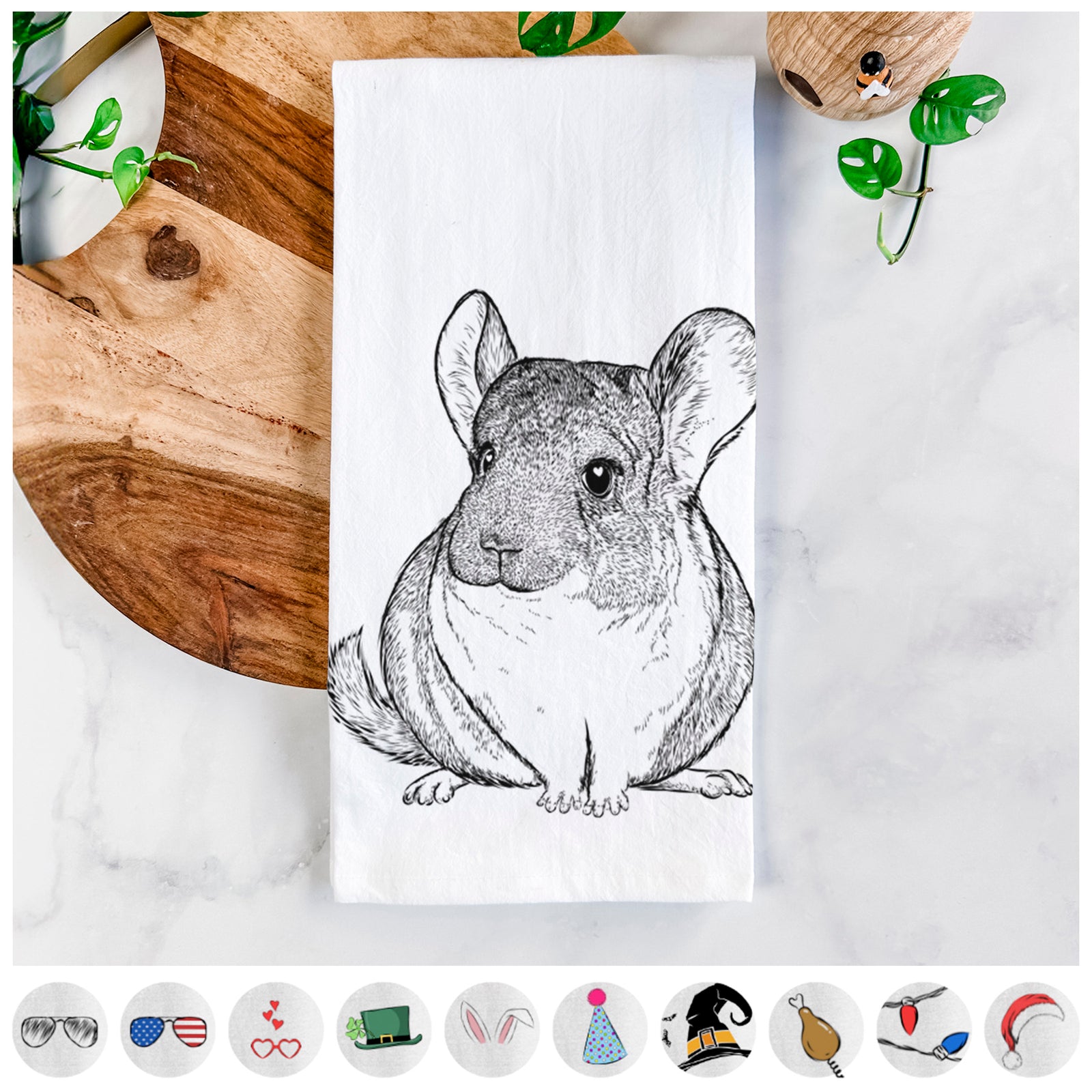 Hand-drawn sketch of Cheddar the Chinchilla on a tea towel, shown with icons of the other available costume styles
