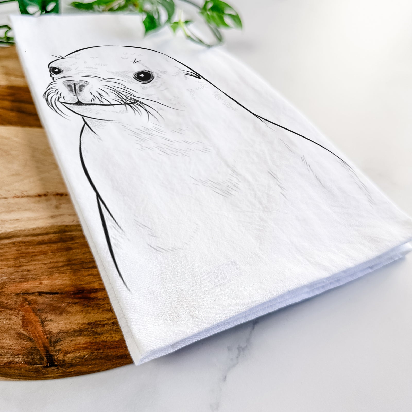 Hand-drawn sketch of Chip the California Sea Lion on a tea towel