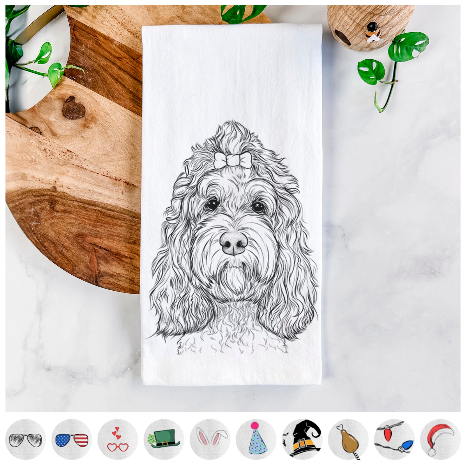 Hand-drawn sketch of Chloe the Cockapoo on a tea towel, shown with icons of the other available costume styles