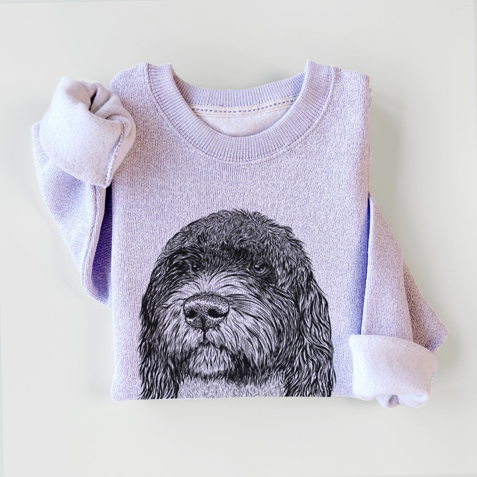 Hand-drawn sketch of Chris the Portuguese Water Dog on an Ice Purple knit sweatshirt