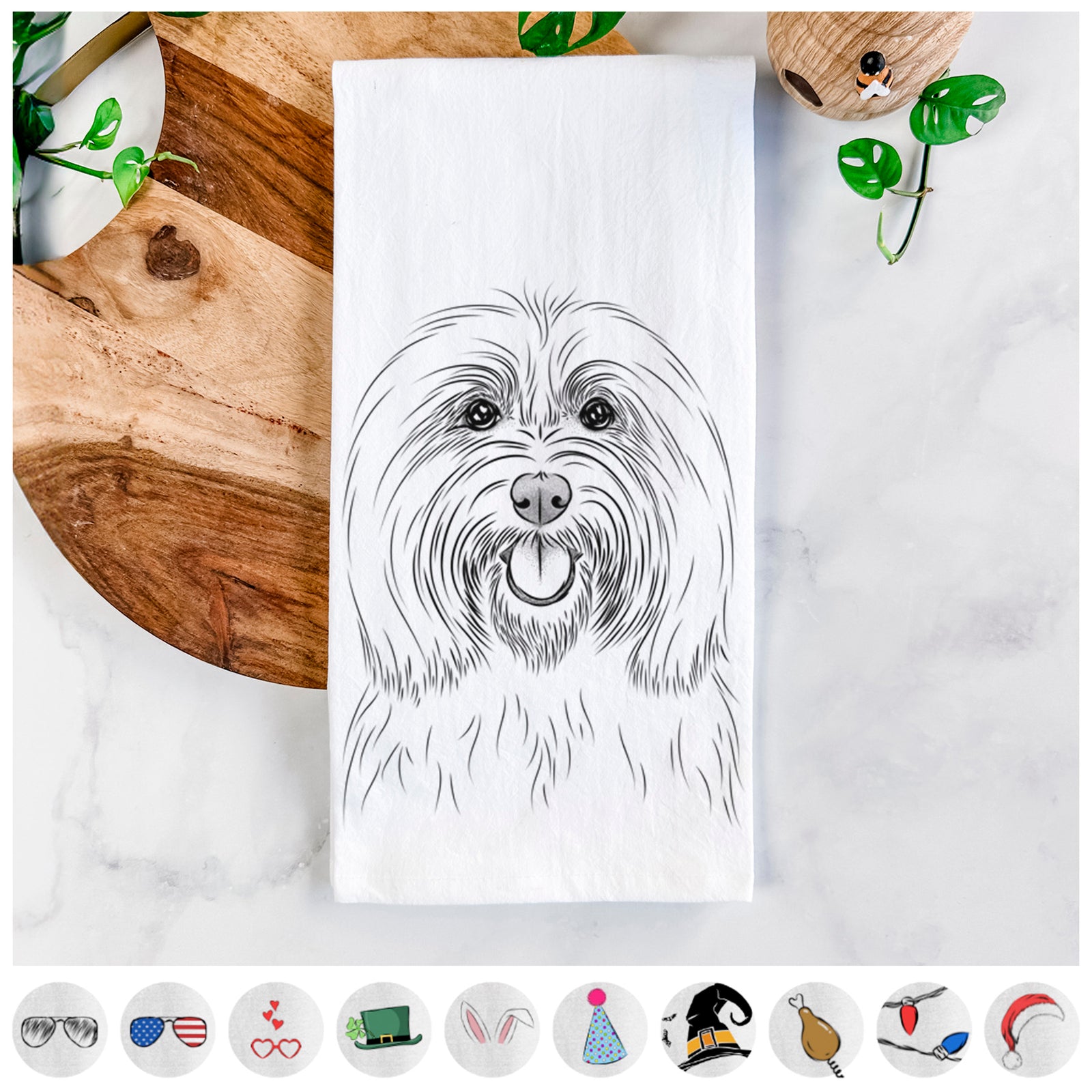 Hand-drawn sketch of Claude the Coton de Tulear on a tea towel, shown with icons of the other available costume styles