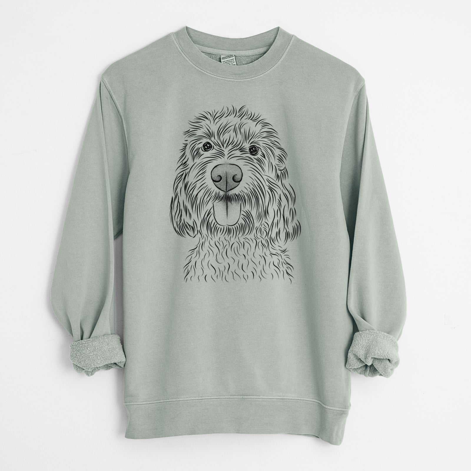 Hand-drawn sketch of Clover the Cockapoo on a Sage Unisex pigment dyed crew sweatshirt