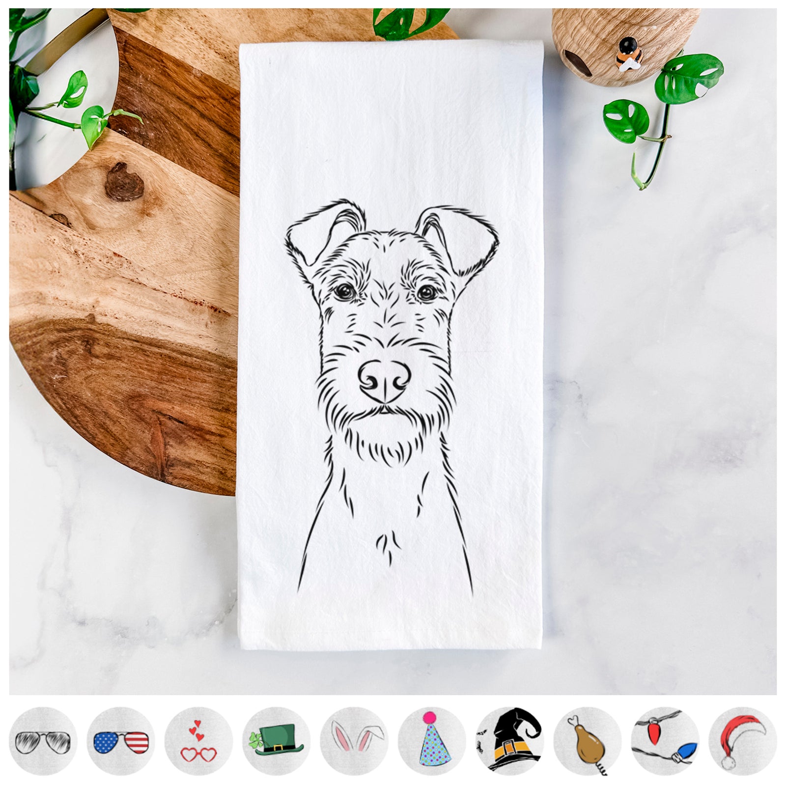 Hand-drawn sketch of Connor the Irish Terrier on a tea towel, shown with icons of the other available costume styles