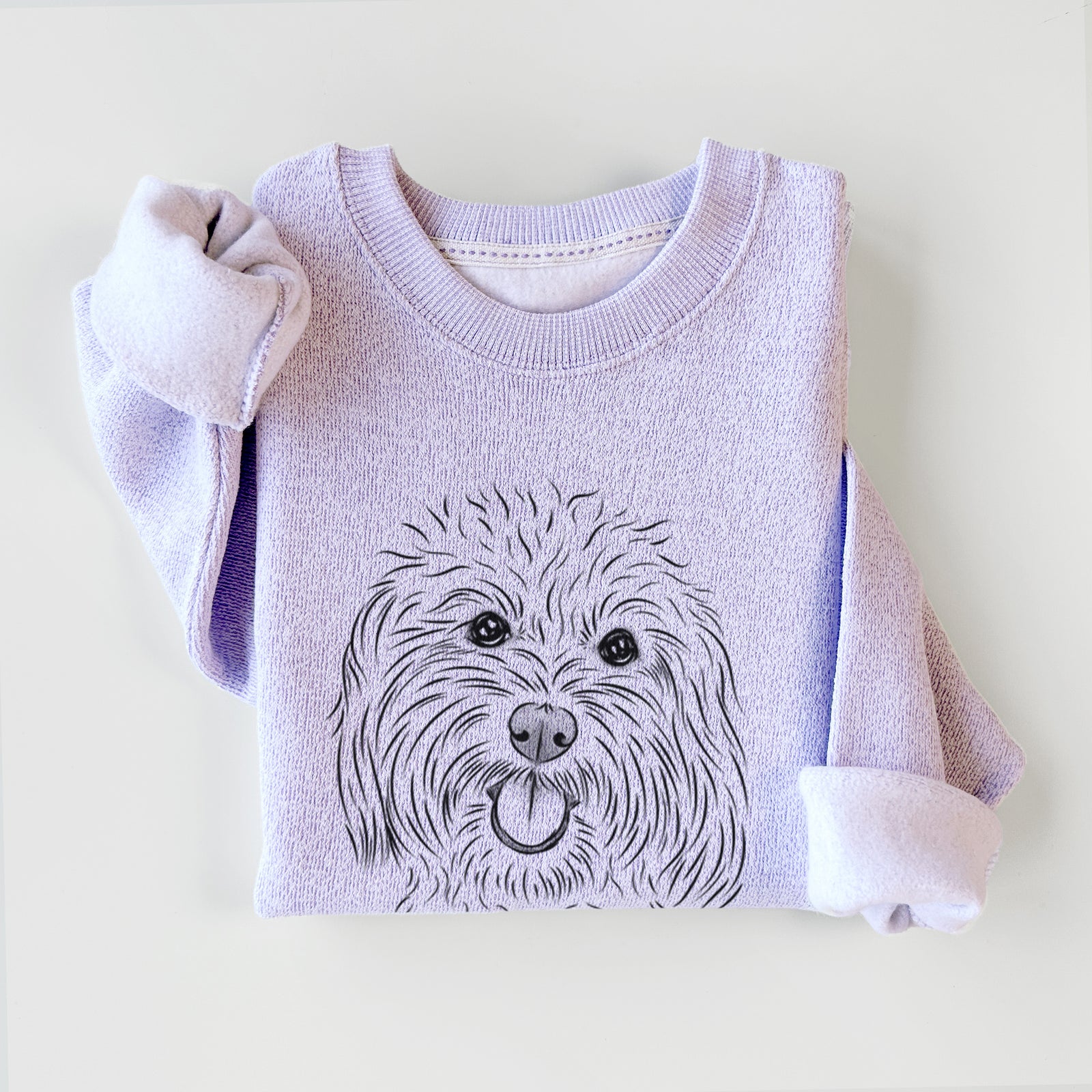 Hand-drawn sketch of Cuddles the Coton de Tulear on an Ice Purple knit sweatshirt