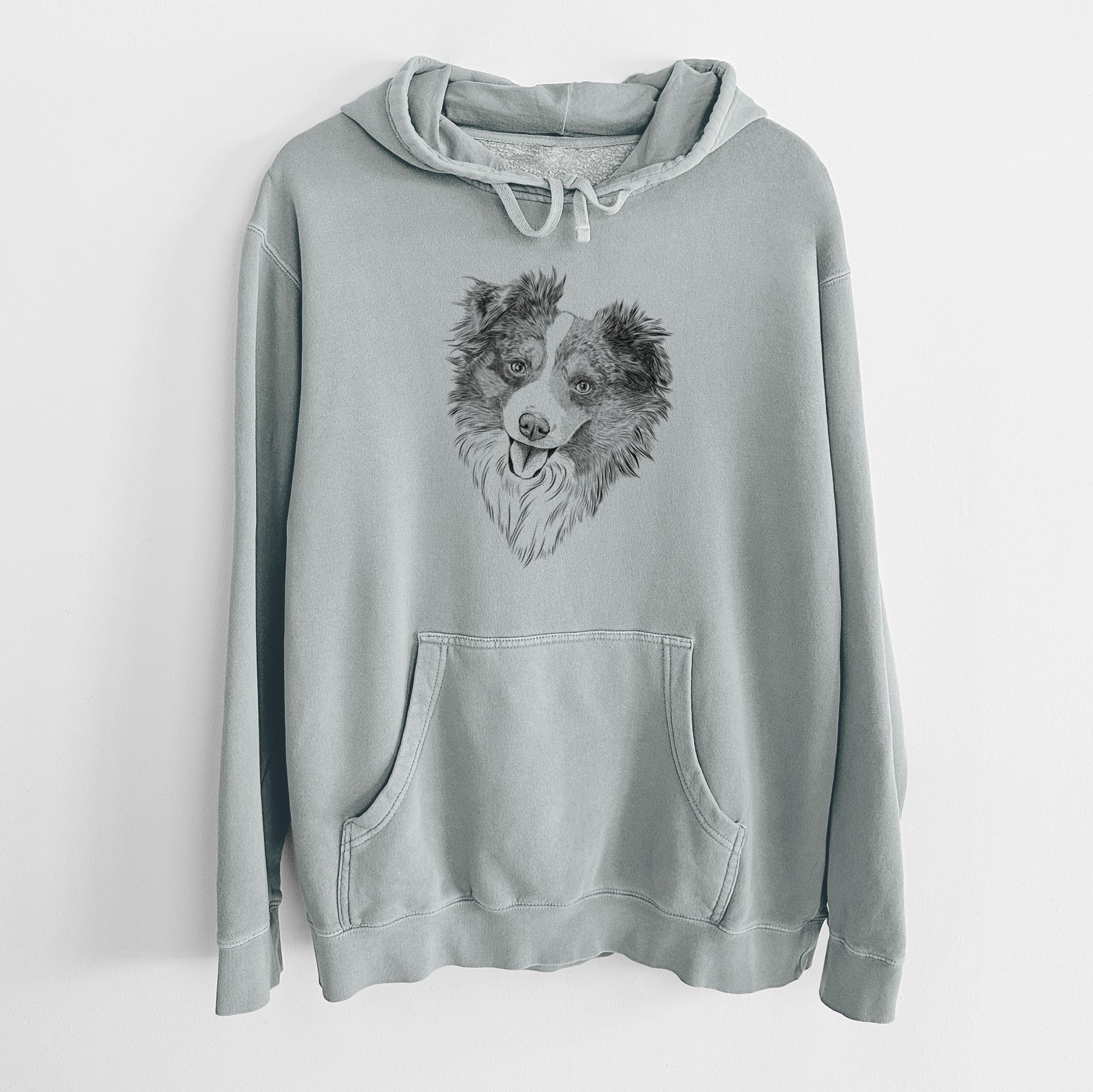 Hand-drawn sketch of Doc the Mini Aussie on a Sage Unisex pigment dyed hoodie