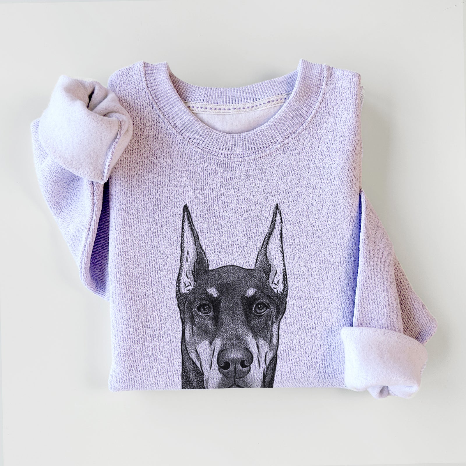 Hand-drawn sketch of Drake the Doberman Pinscher on an Ice Purple knit sweatshirt