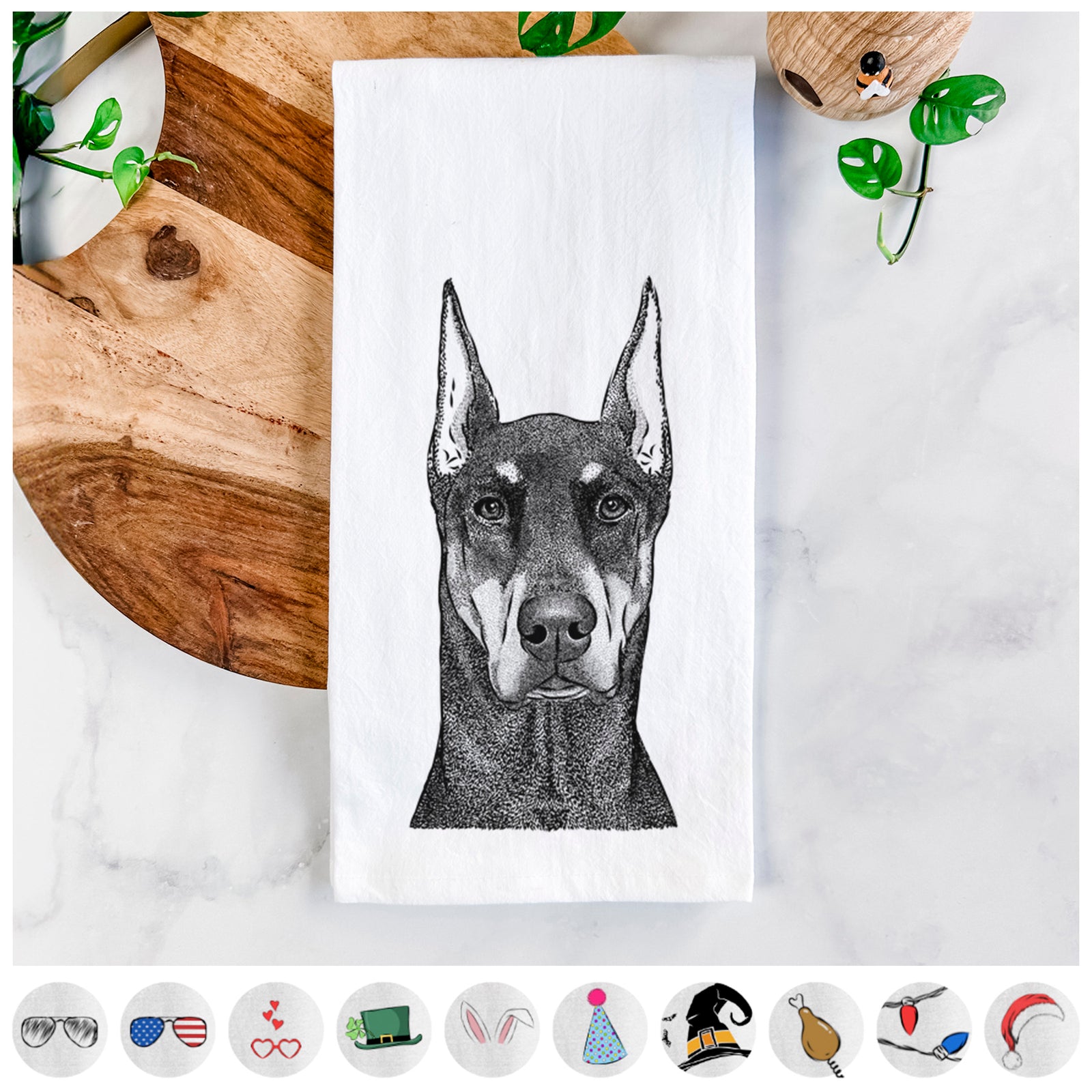Hand-drawn sketch of Drake the Doberman Pinscher on a tea towel, shown with icons of the other available costume styles