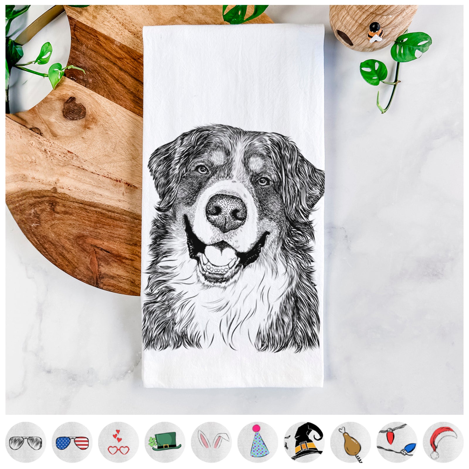 Hand-drawn sketch of Eiger the Bernese Mountain Dog on a tea towel, shown with icons of the other available costume styles