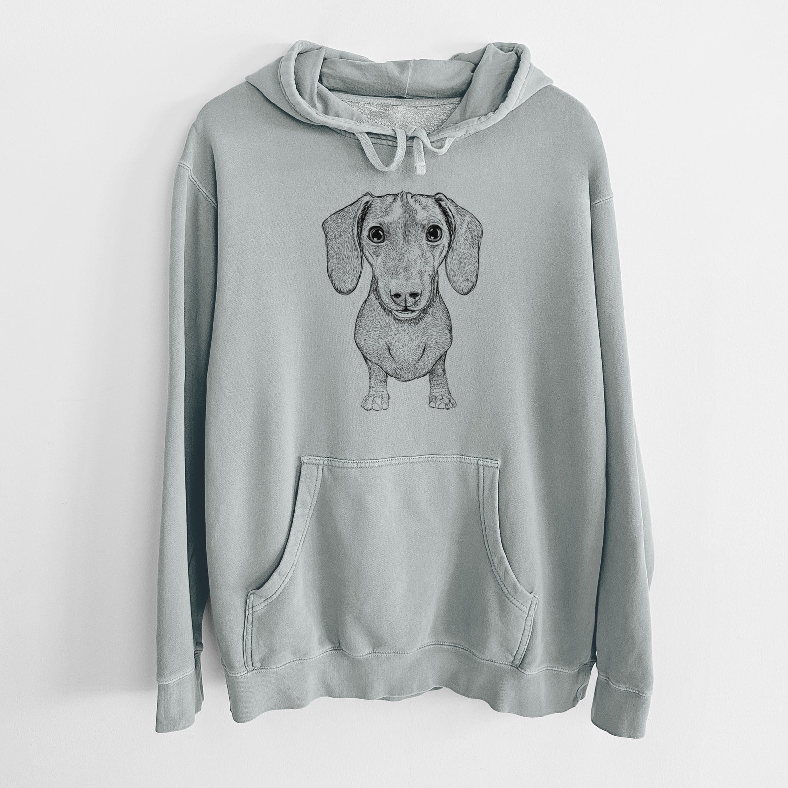 Hand-drawn sketch of Ernie the Mini Dachshund on a Sage Unisex pigment dyed hoodie