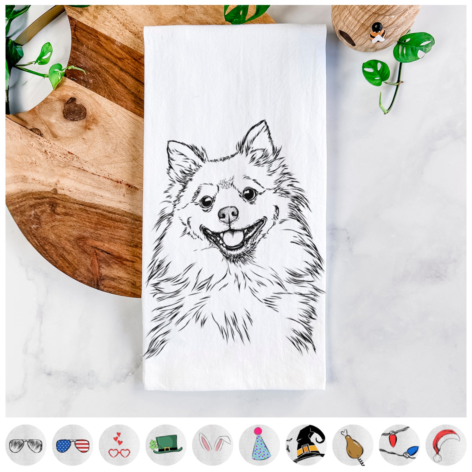 Hand-drawn sketch of Fibi the Spitz on a tea towel, shown with icons of the other available costume styles