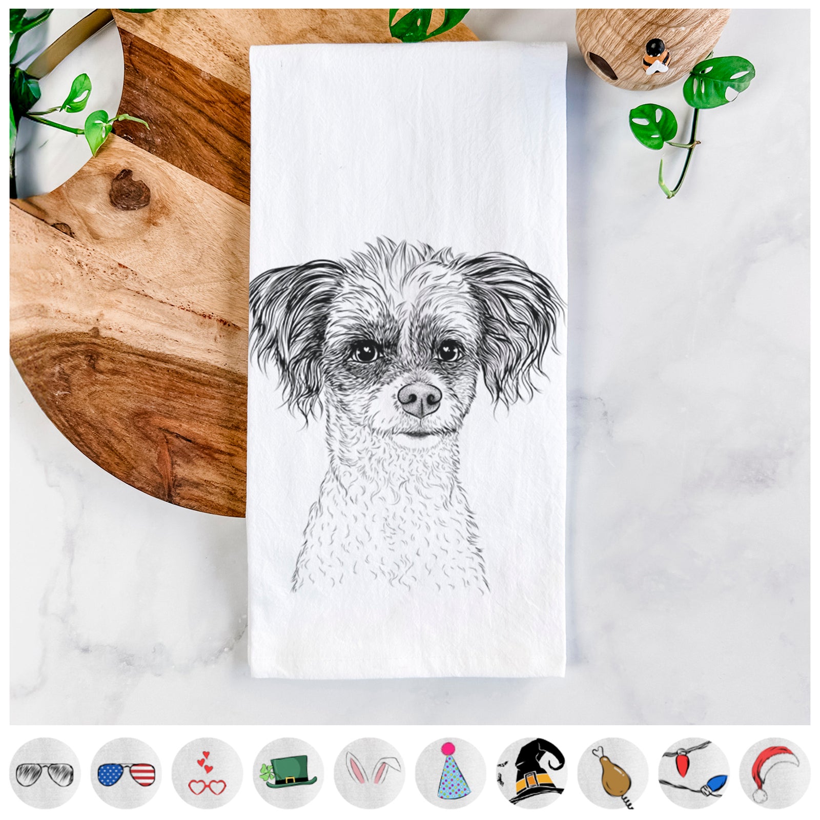 Hand-drawn sketch of Finley the Papillon Mix on a tea towel, shown with icons of the other available costume styles