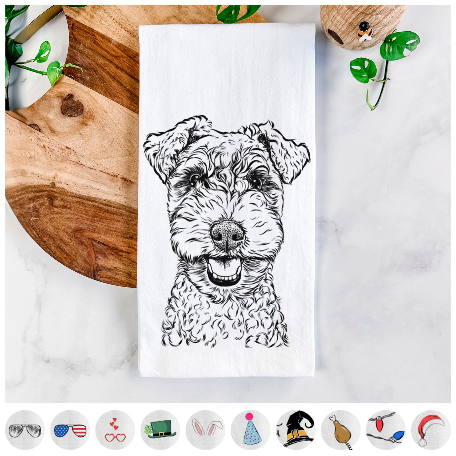 Hand-drawn sketch of Fintan the Irish Troodle on a tea towel, shown with icons of the other available costume styles
