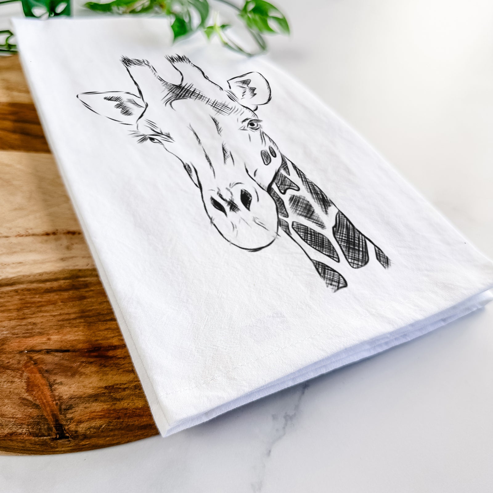Hand-drawn sketch of Geoffrey the Giraffe on a tea towel