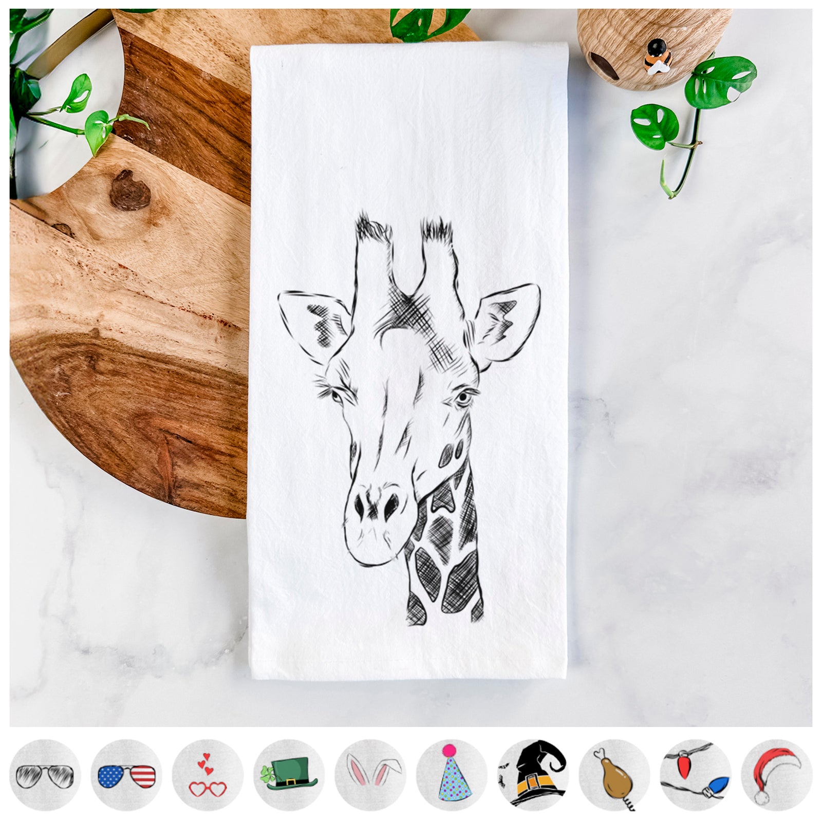 Hand-drawn sketch of Geoffrey the Giraffe on a tea towel, shown with icons of the other available costume styles