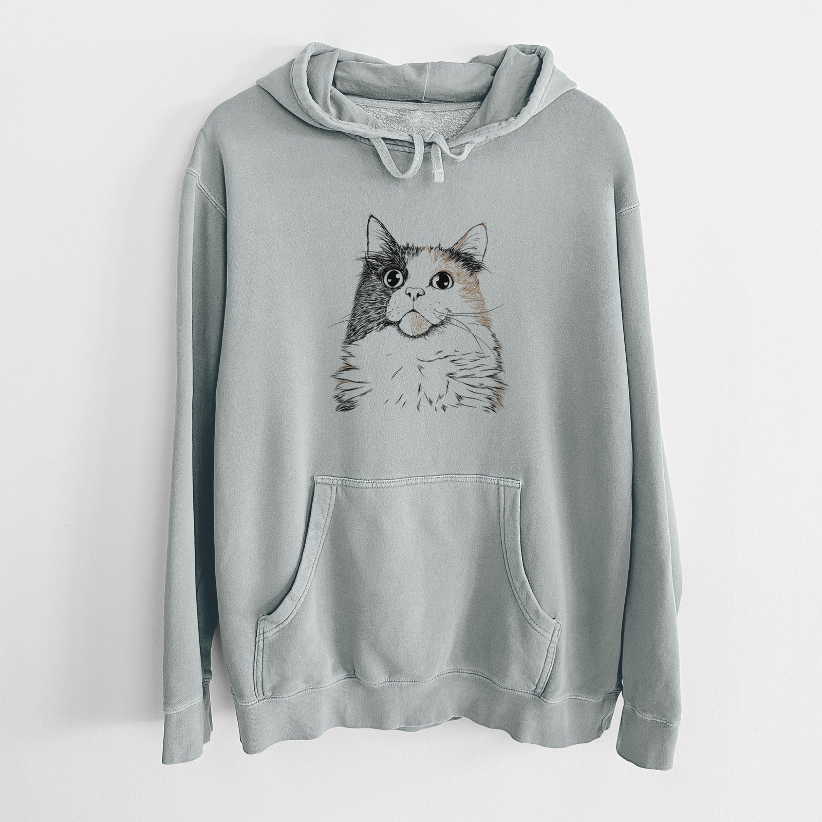 Hand-drawn sketch of Greta the Calico Cat on a Sage Unisex pigment dyed hoodie