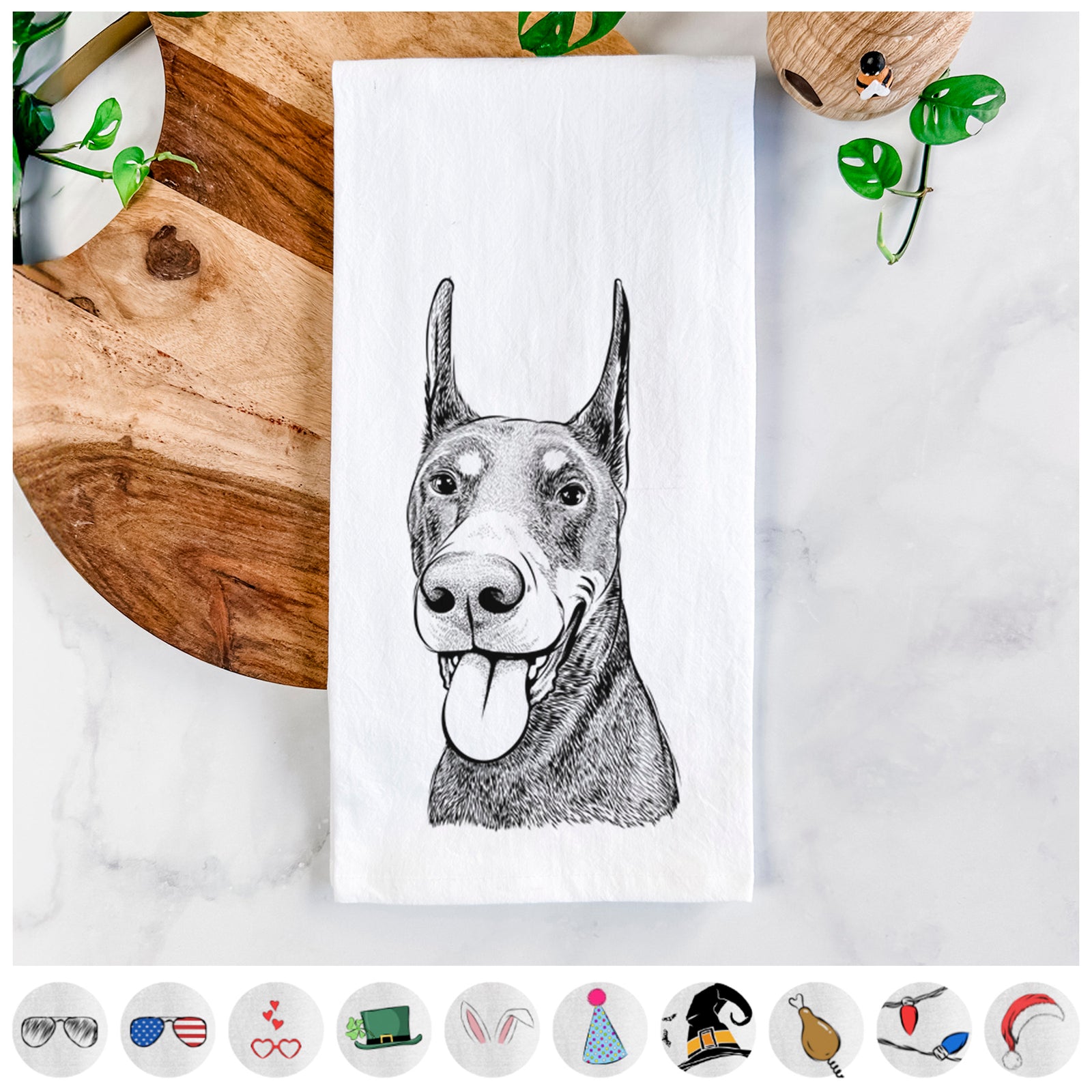 Hand-drawn sketch of Happy Sunny the Doberman Pinscher on a tea towel, shown with icons of the other available costume styles