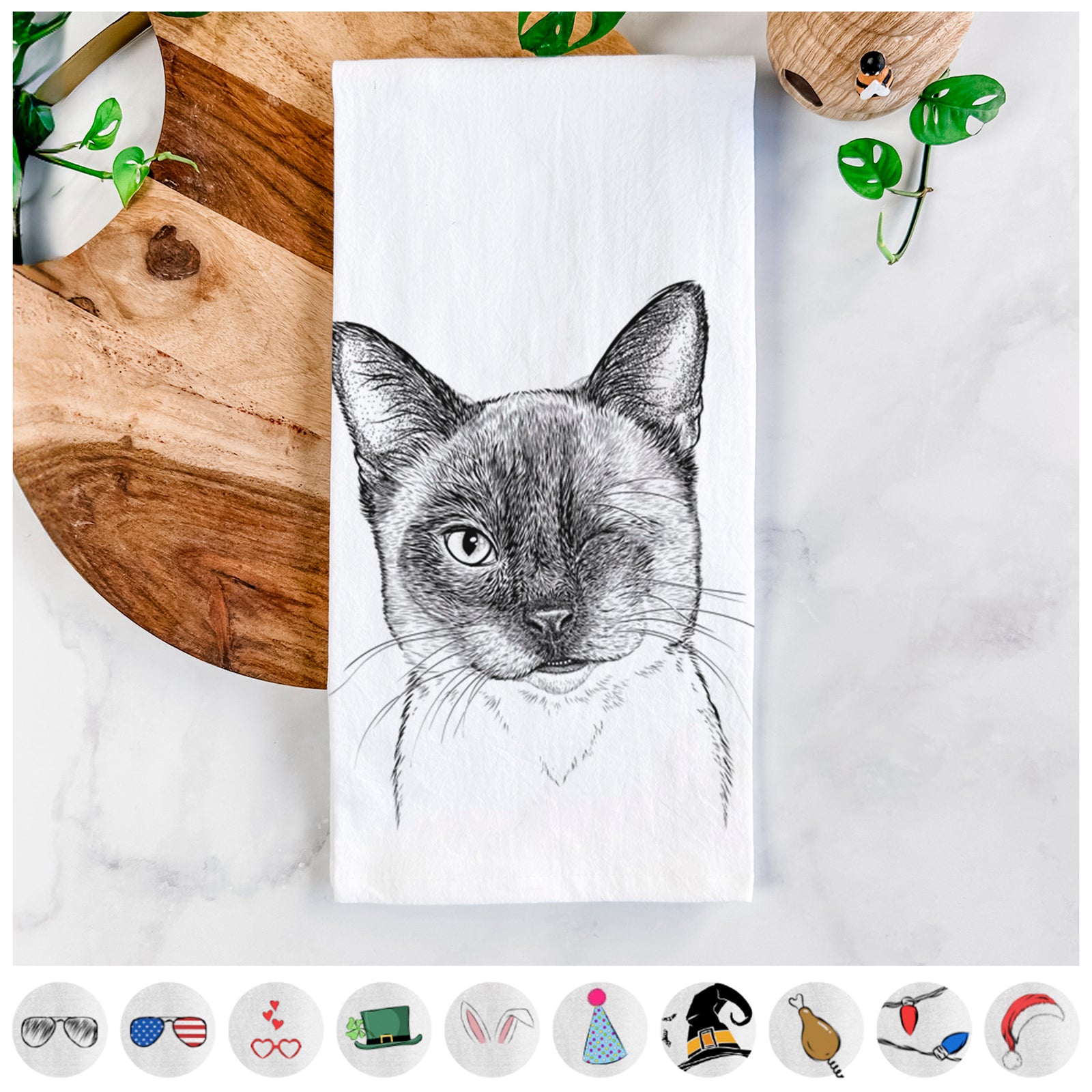 Hand-drawn sketch of Hoggle the Siamese Cat on a tea towel, shown with icons of the other available costume styles