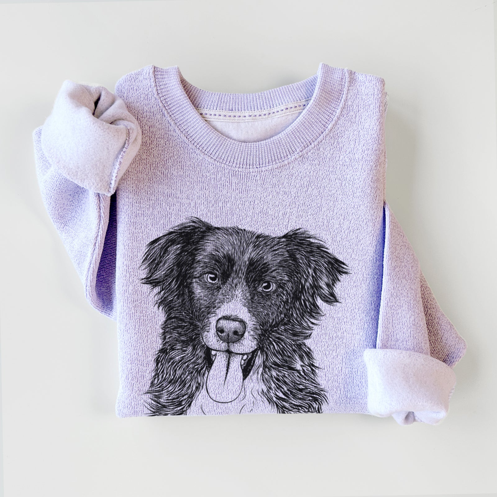 Hand-drawn sketch of Indi the Border Collie on an Ice Purple knit sweatshirt