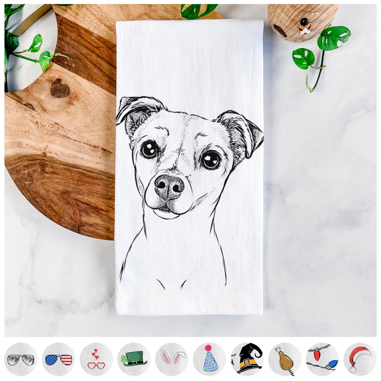 Hand-drawn sketch of Izzy the Chiweenie on a tea towel, shown with icons of the other available costume styles