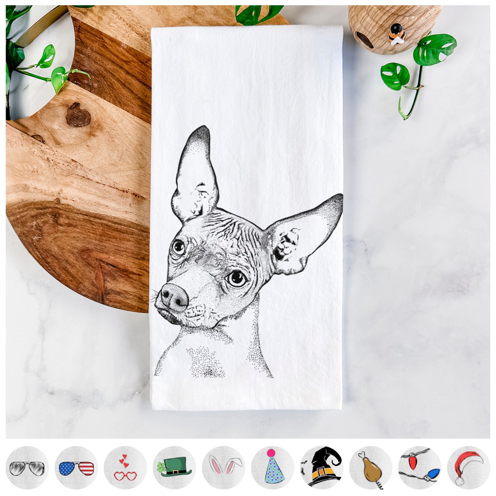 Hand-drawn sketch of Kahlo the Xoloitzcuintli on a tea towel, shown with icons of the other available costume styles