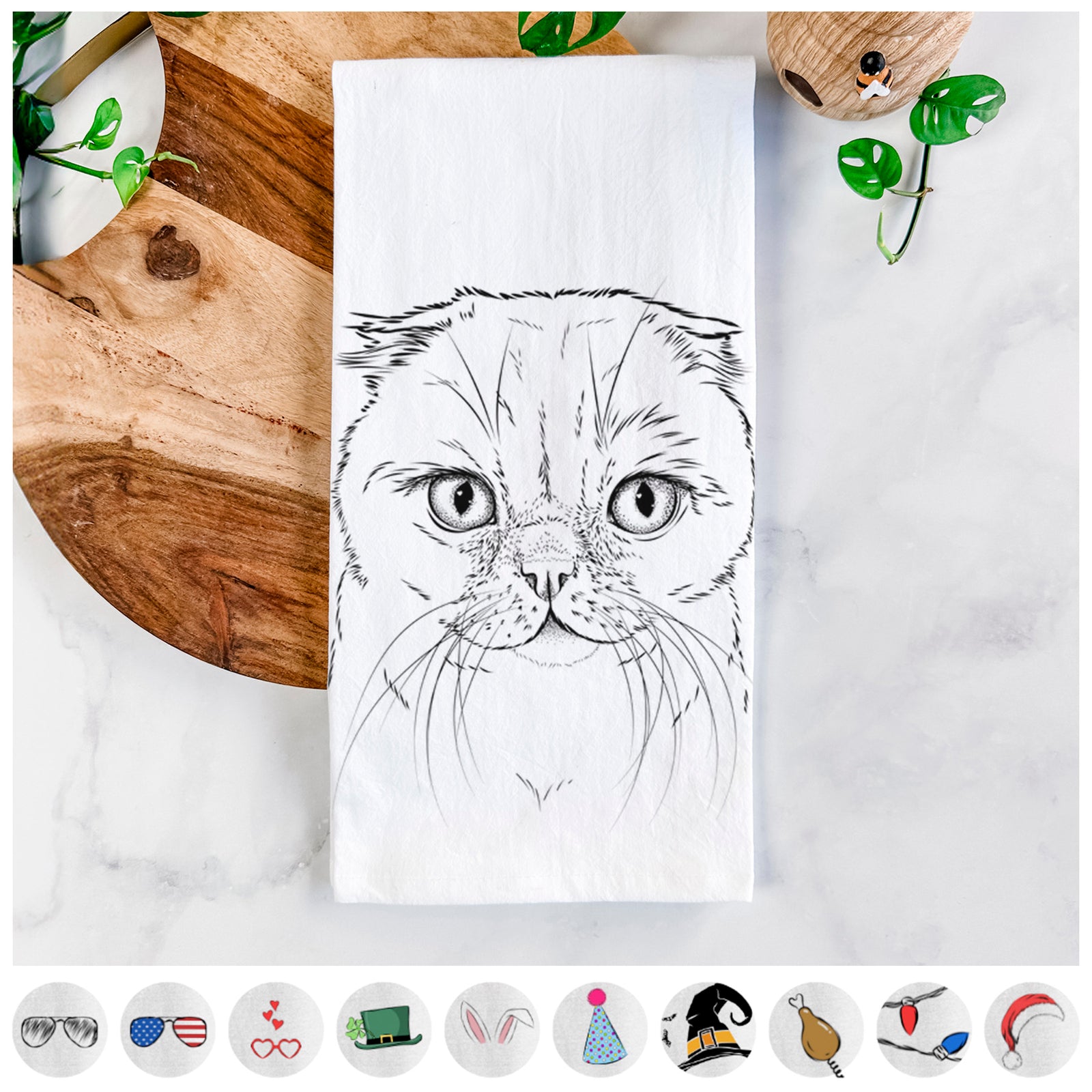 Hand-drawn sketch of Lina the Exotic Fold Cat on a tea towel, shown with icons of the other available costume styles