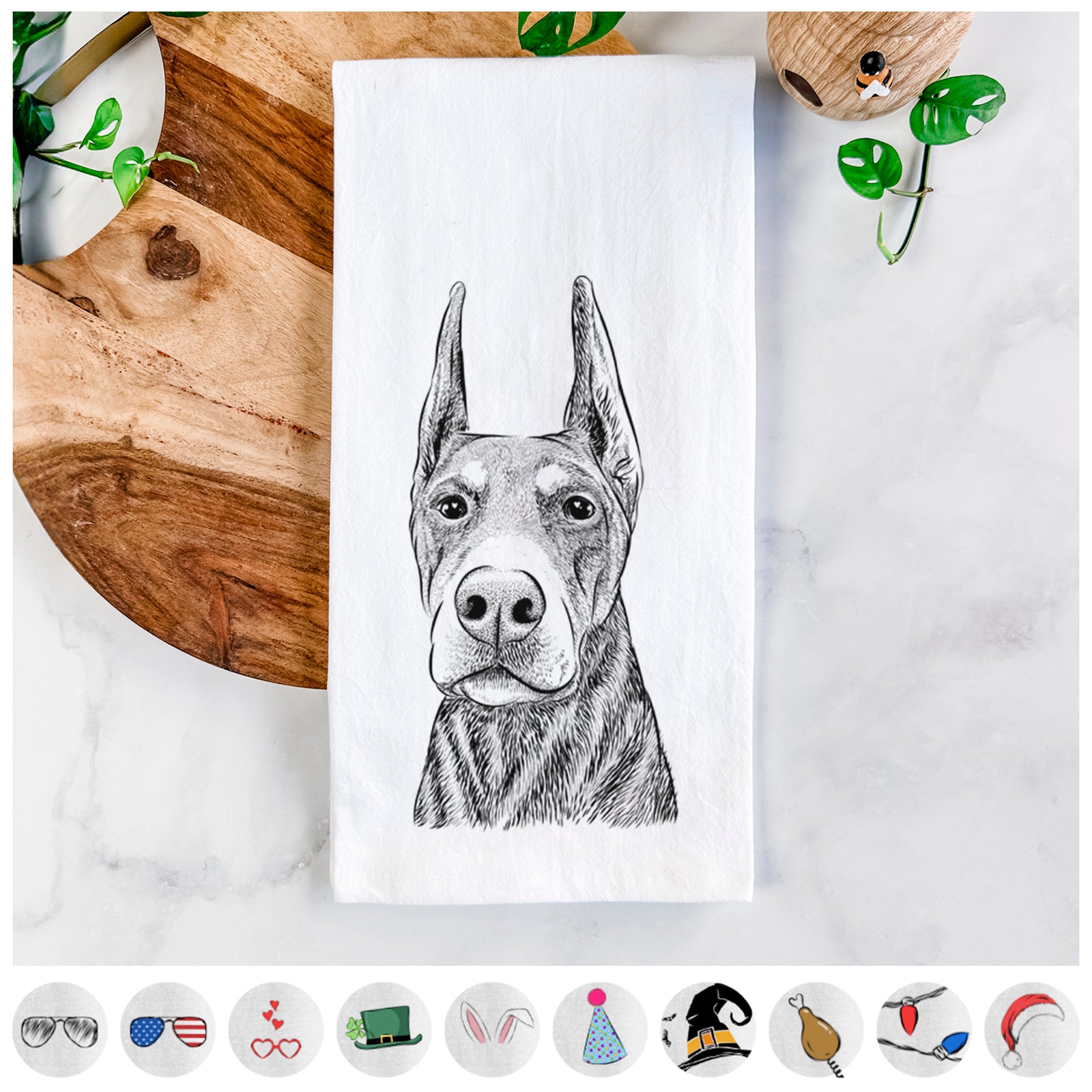 Hand-drawn sketch of Luna the Doberman Pinscher on a tea towel, shown with icons of the other available costume styles